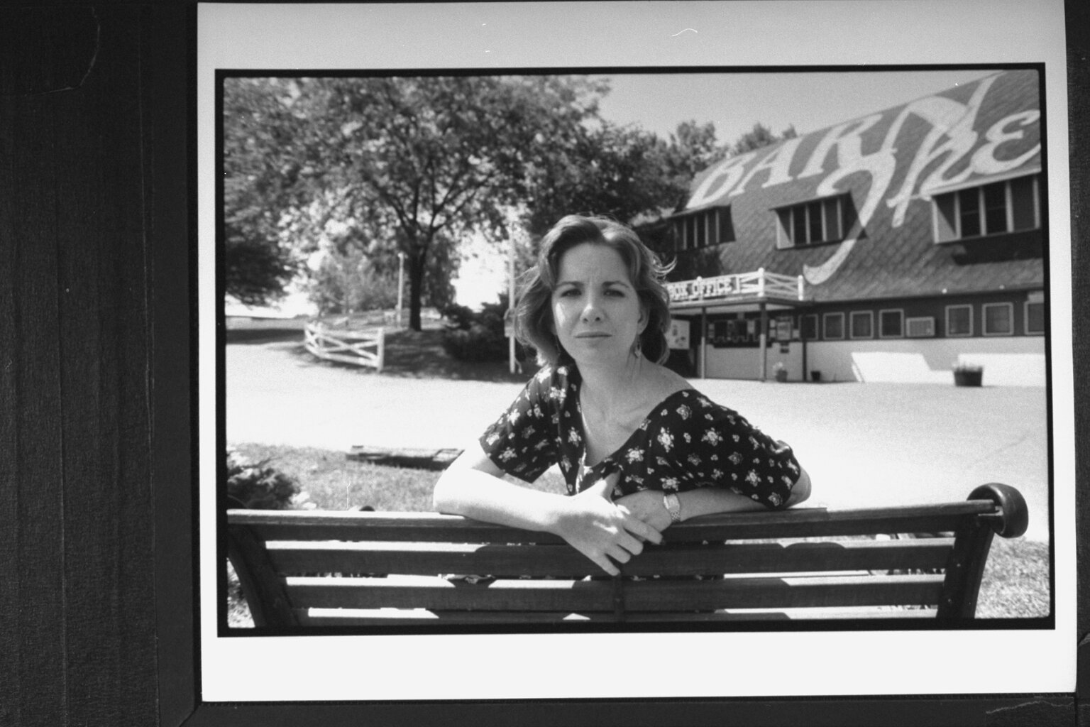 Melissa Gilbert posing on bench in front of the Barn Theatre where she was performing in her playwright husband Bo Brinkman's new play