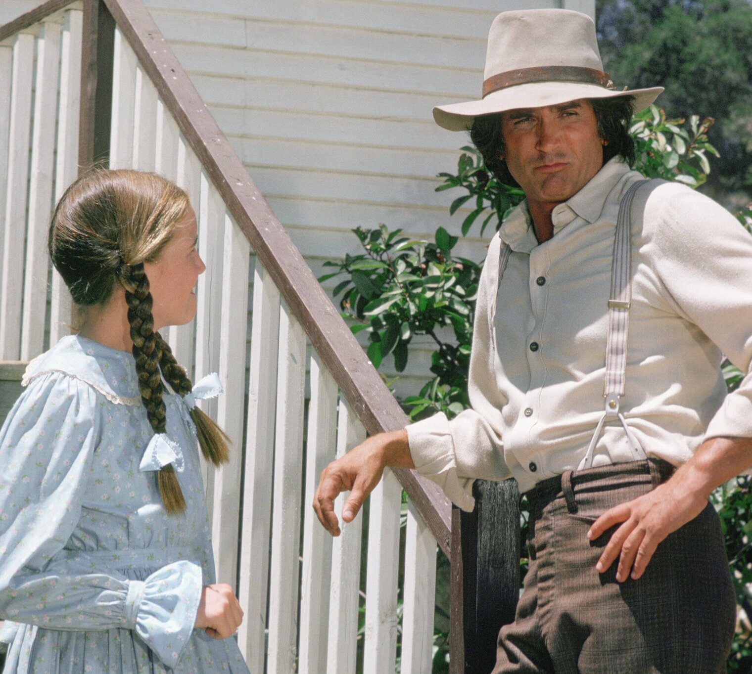 Melissa Gilbert and Michael Landon on the set of 'Little House on the Prairie.' Gilbert is look up at Landon on the porch steps.