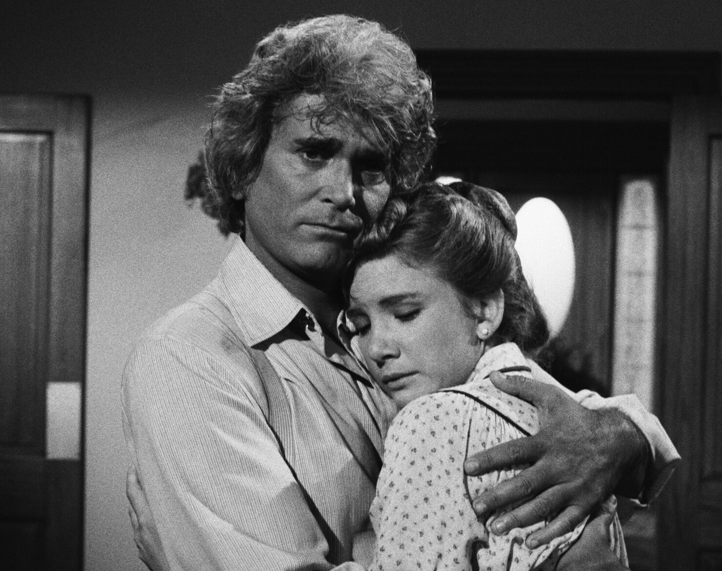 Michael Landon hugging Melissa Gilbert in black and white. A still from 'Little House: A New Beginning'