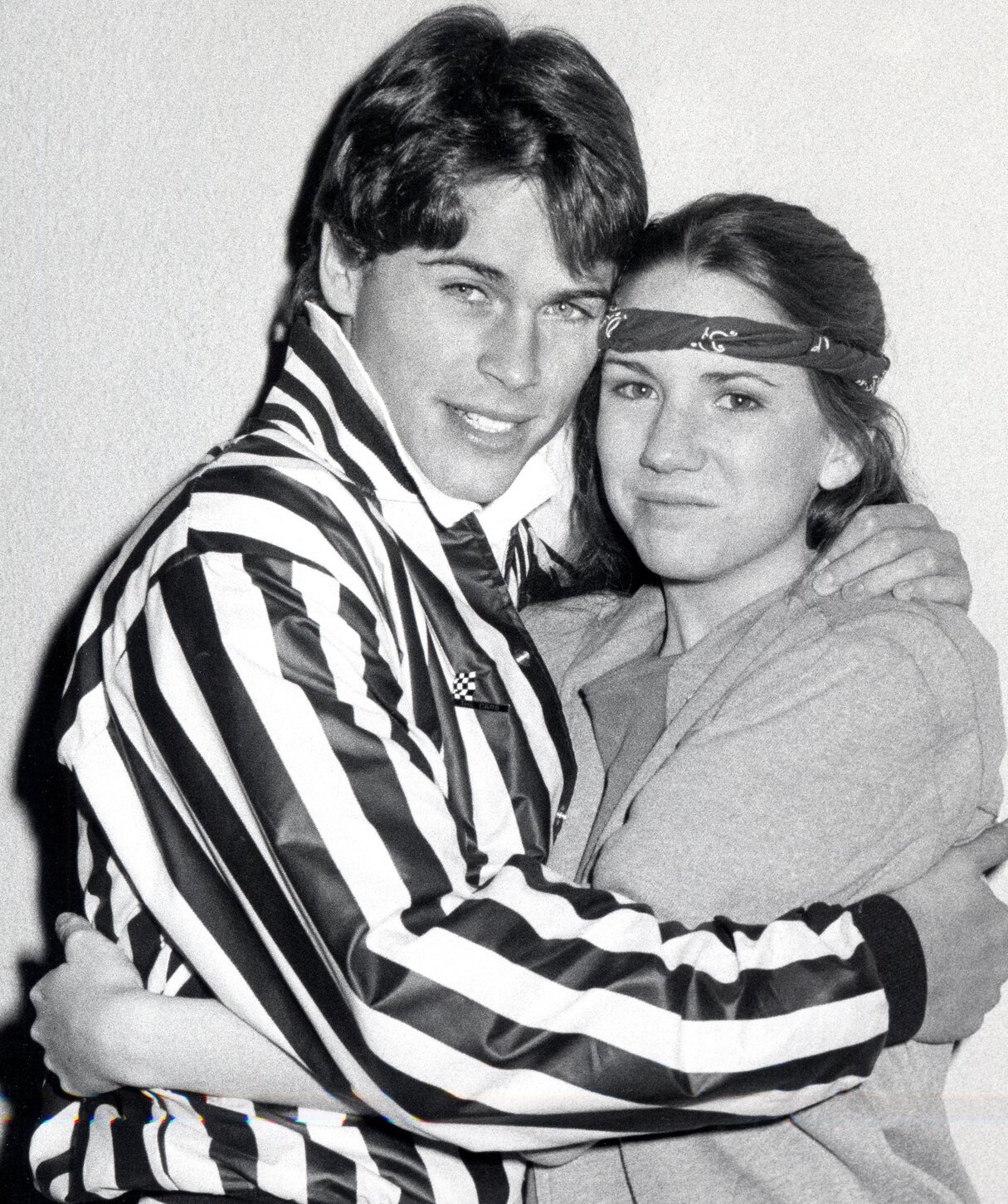 Rob Lowe and Melissa Gilbert embrace in black and white