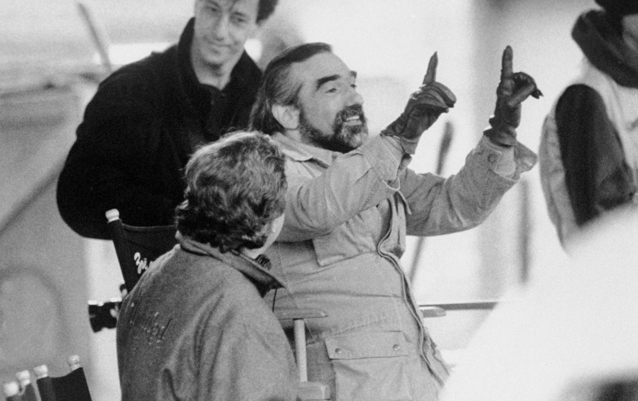 Martin Scorsese framing a shot in the director's chair in the 1980s