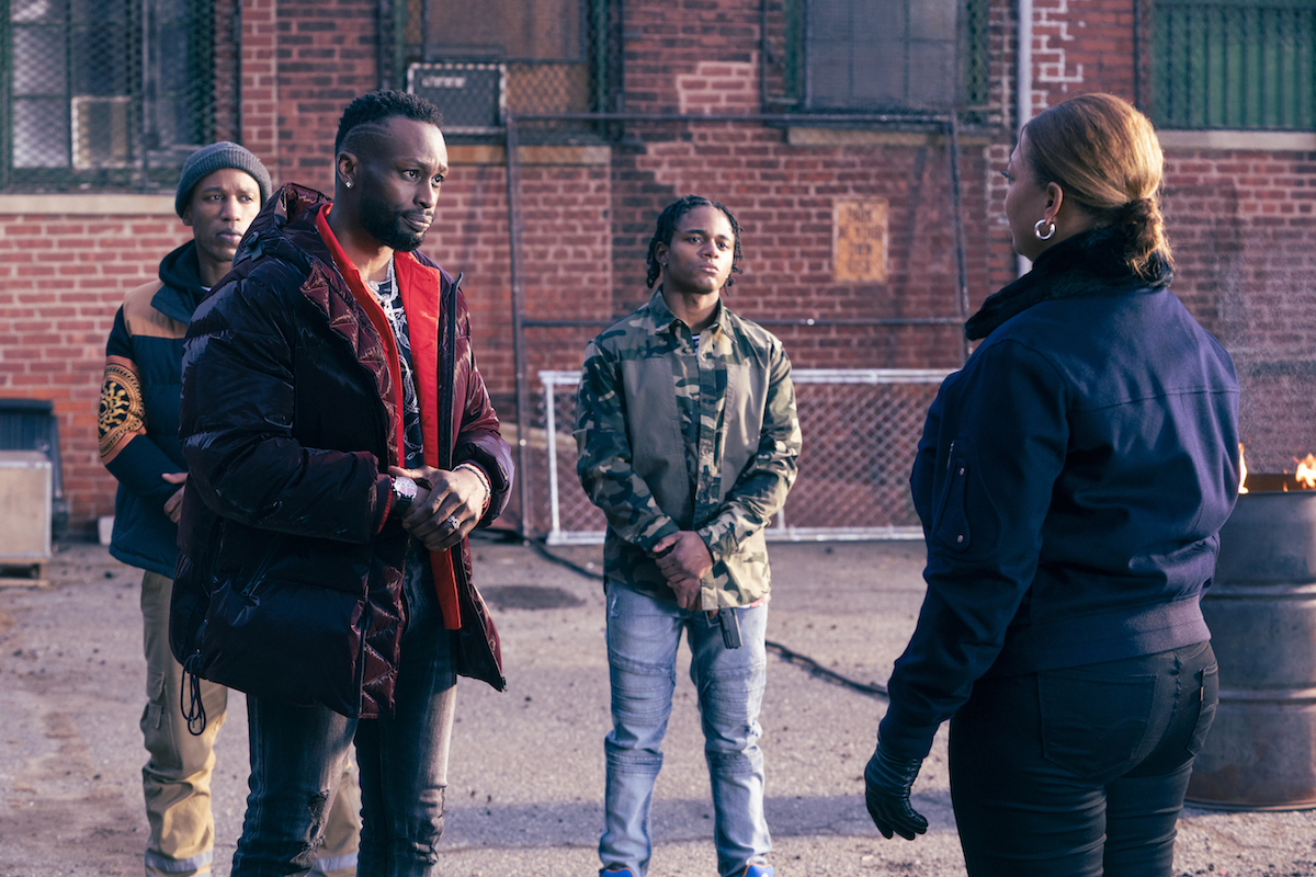 Queen Latifah as Robyn McCall talking to a group of three men in The Equalizer