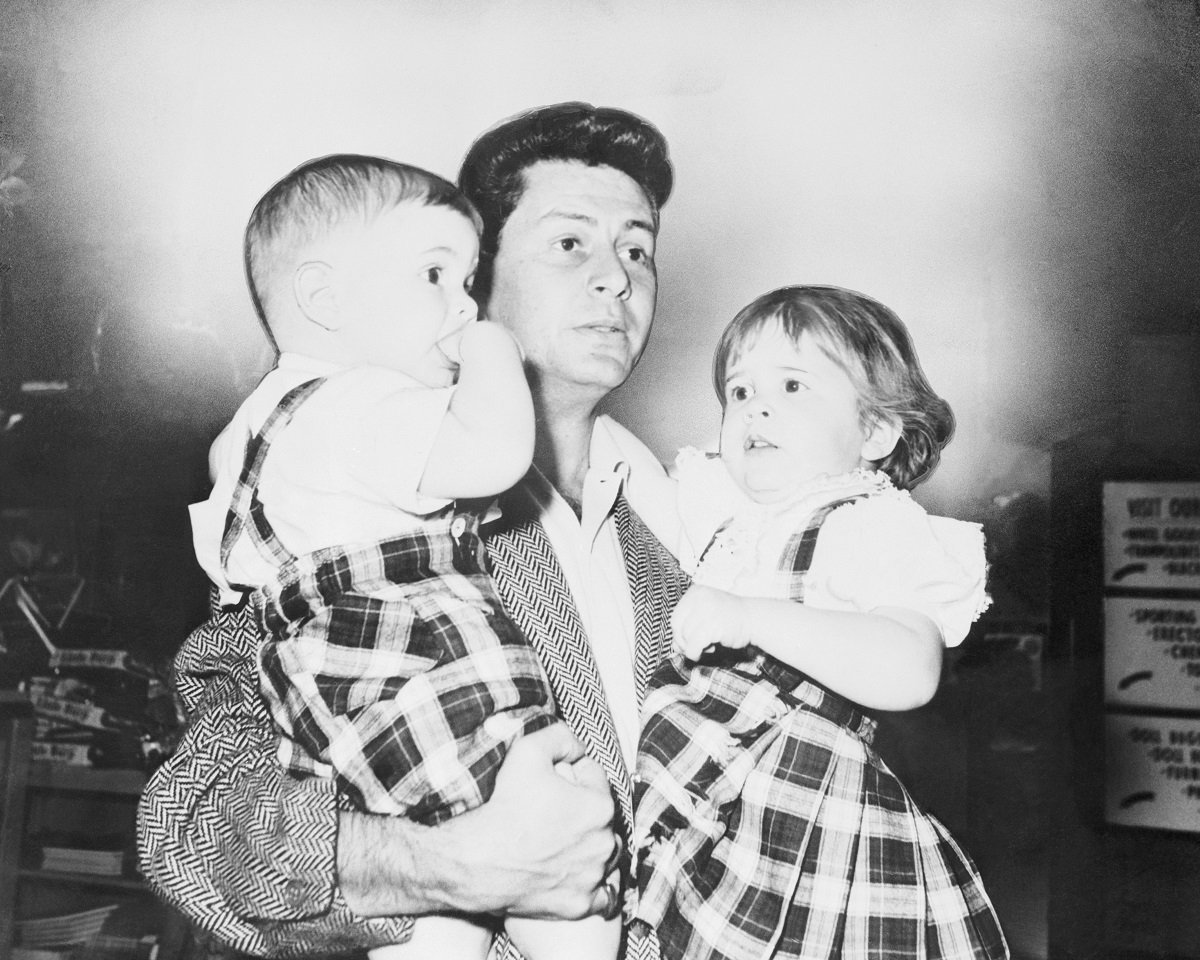 Eddie Fisher holds his two children, Todd 1, and Carrie, 2, (R), in March 1959.