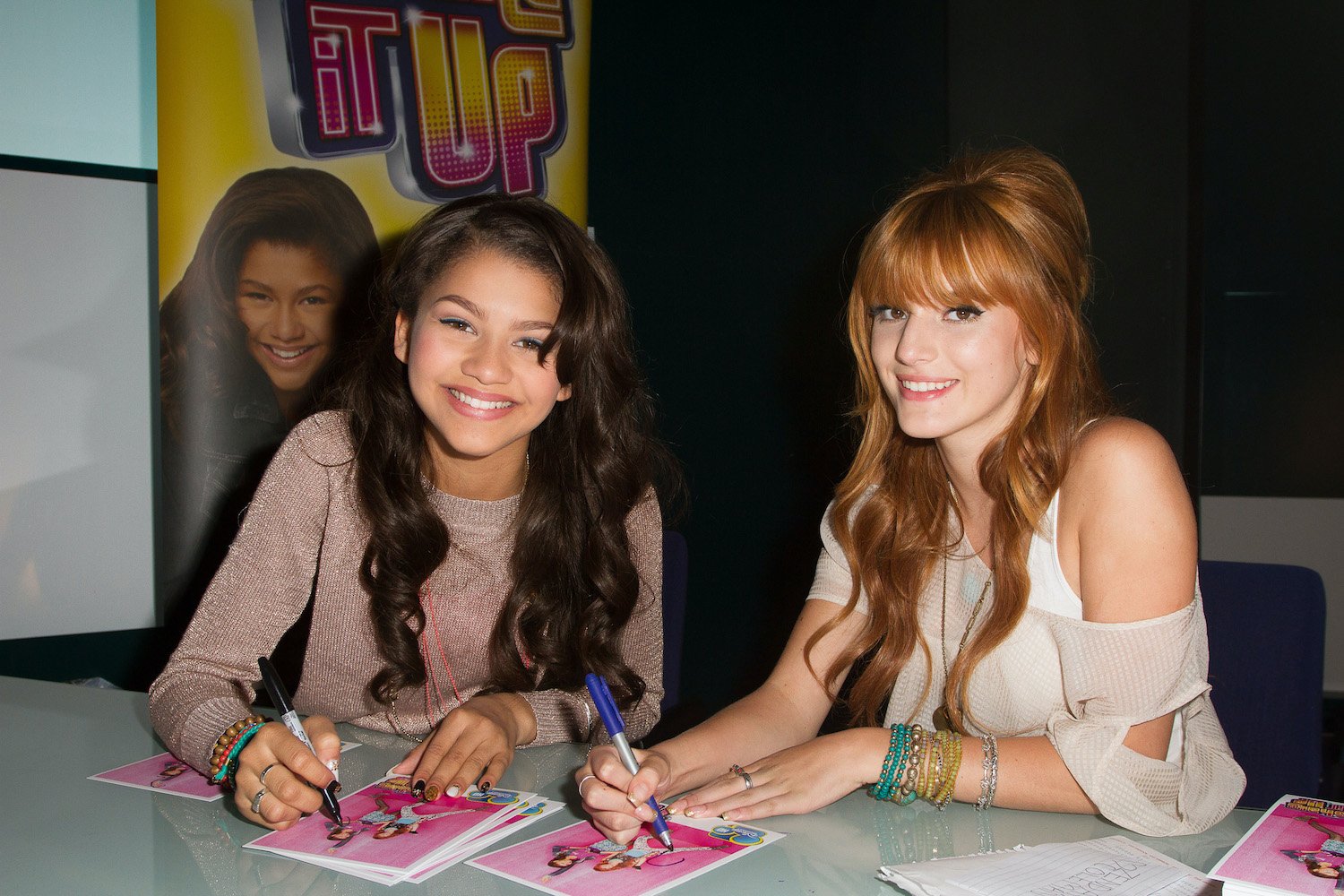 Bella Thorne and Zendaya of Disney Channel's "Shake It Up" sign autographs in London
