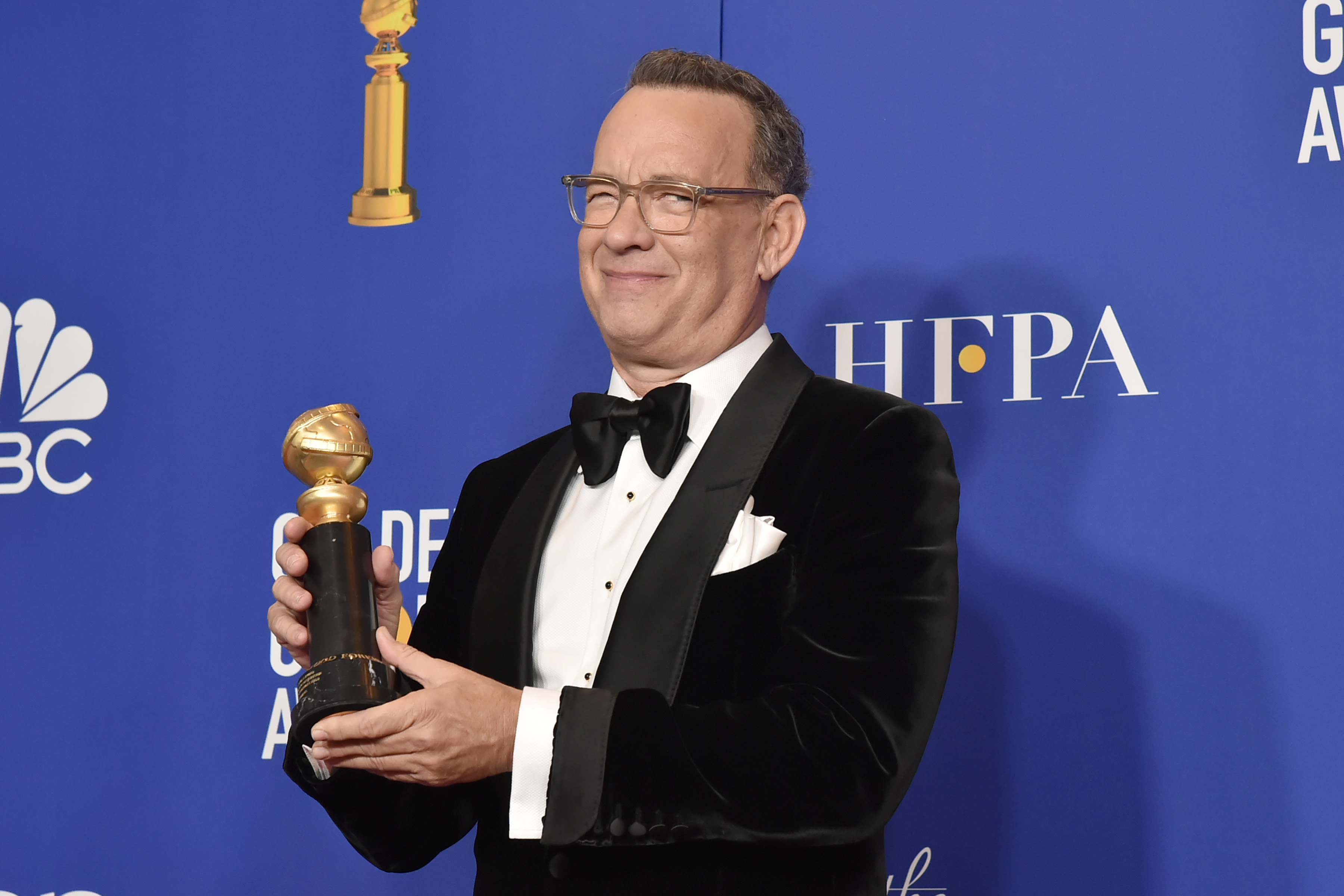 A Beautiful Day in the Neighborhood star Tom Hanks holds a Golden Globe