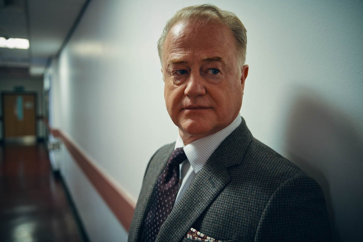 Peter Knox standing in a hallway in A Discovery of Witches
