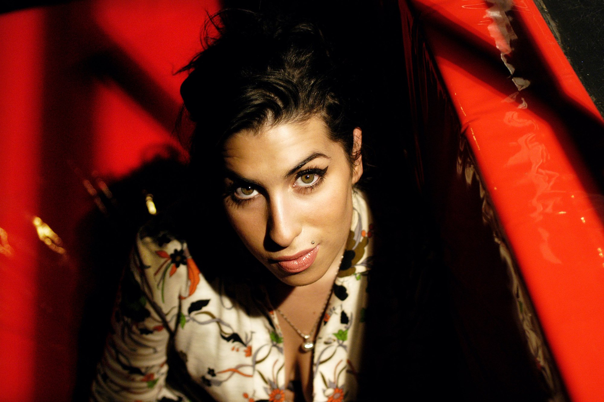 Amy Winehouse smiling, looking up at the camera