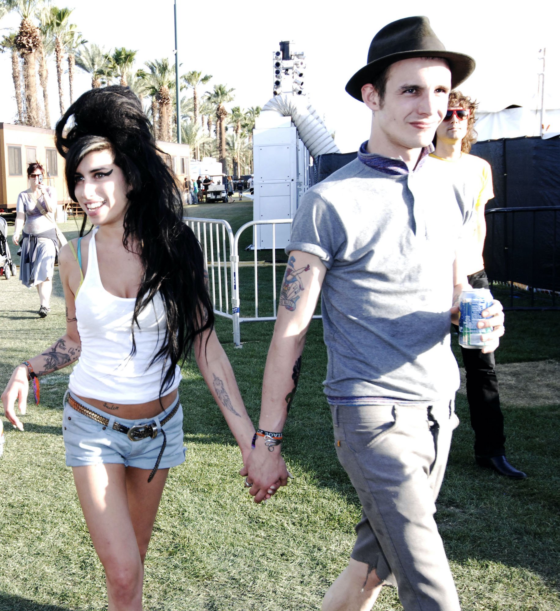 (L-R) Amy Winehouse and Blake Fielder-Civil smiling, holding hands
