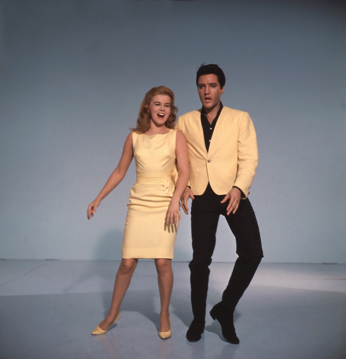 Ann-Margret and Elvis Presley smiling and dancing in a color promotional still from 'Viva Las Vegas' 