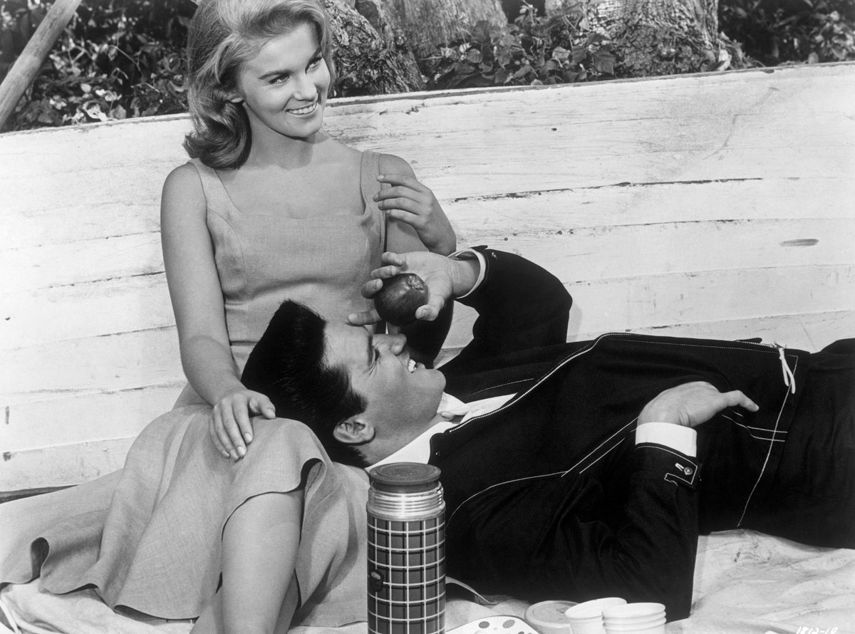 Elvis laughing as he lays his head on Ann-Margret's lap in a scene from 'Viva Las Vegas' (1964)