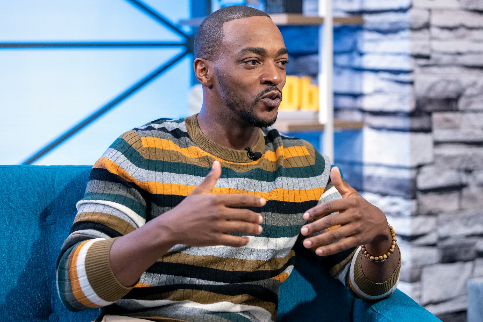 A candid photo of actor Anthony Mackie talking on 'The IMDb Show' in April 2019