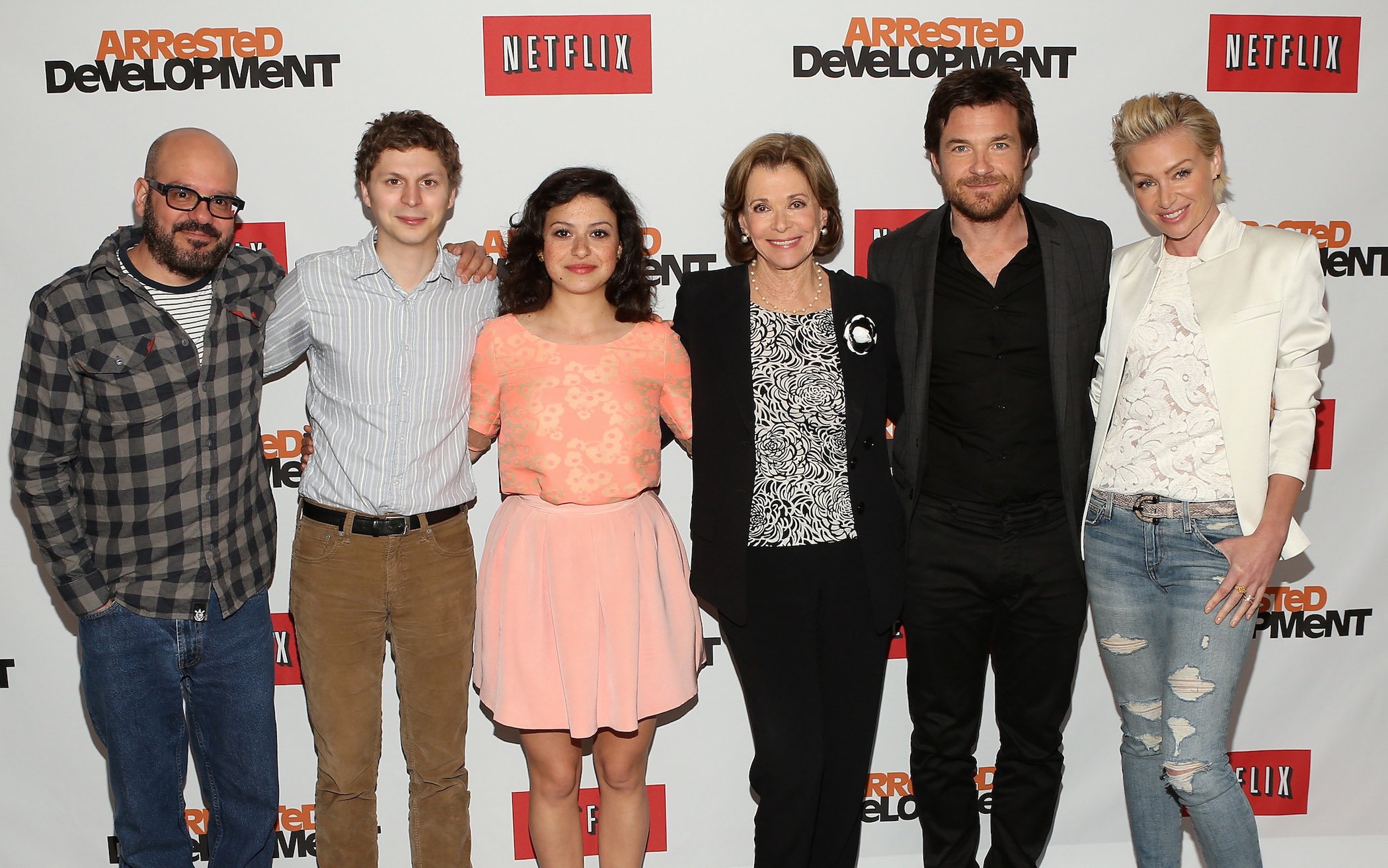 The cast of 'Arrested Development,' including Jessica Walter, standing with her co-stars at a Netflix press conference