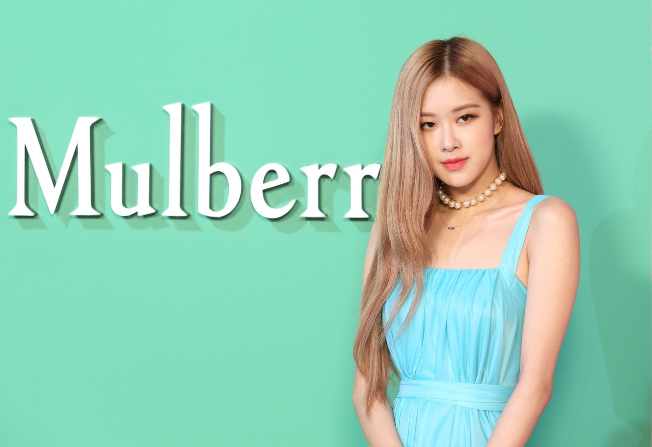 BLACKPINK Rosé standing in front of green background