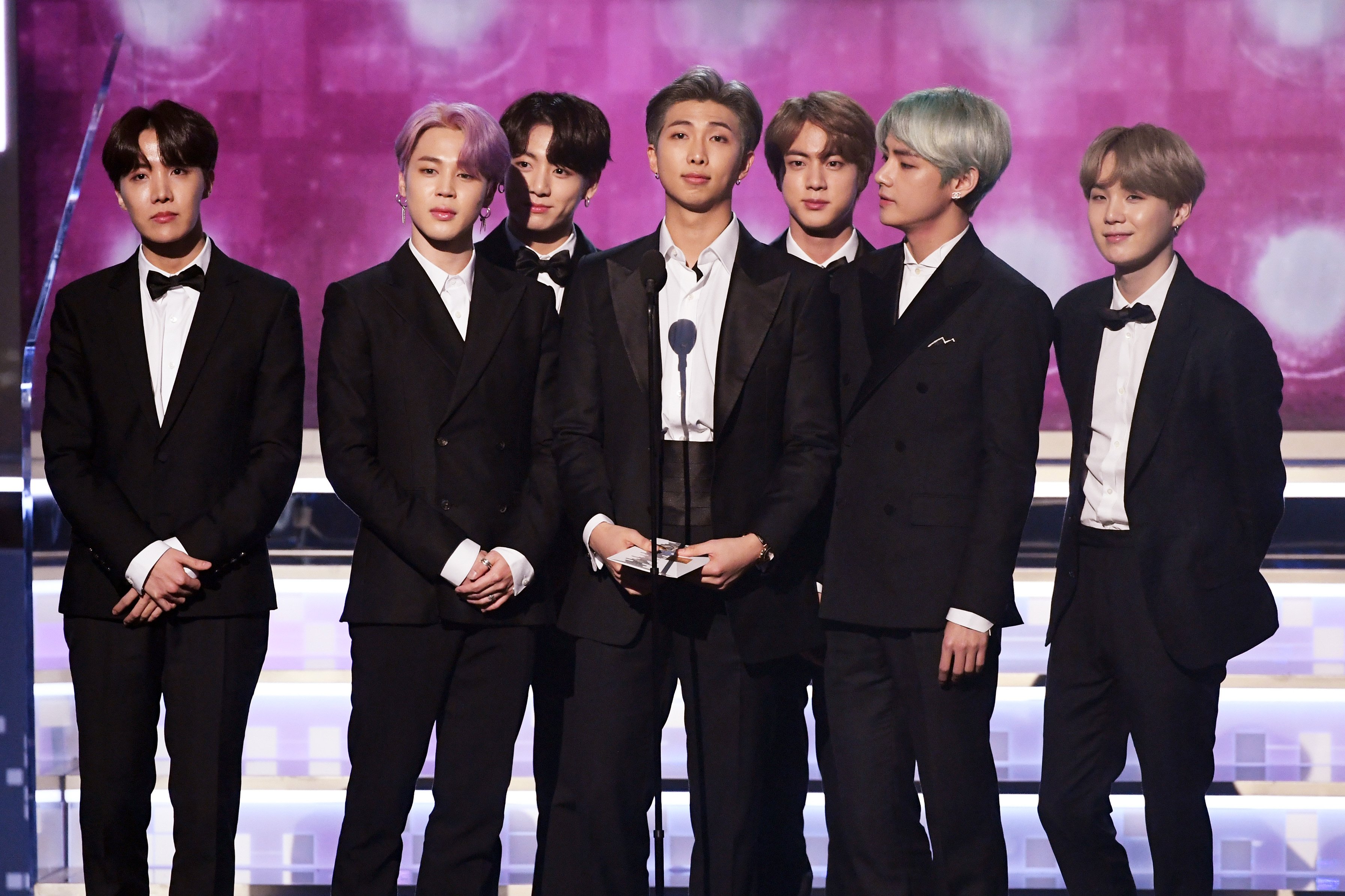 RM, Jimin, V, Jungkook, Jin, J-Hope, and Suga of BTS speak on stage during the 61st Annual GRAMMY Awards