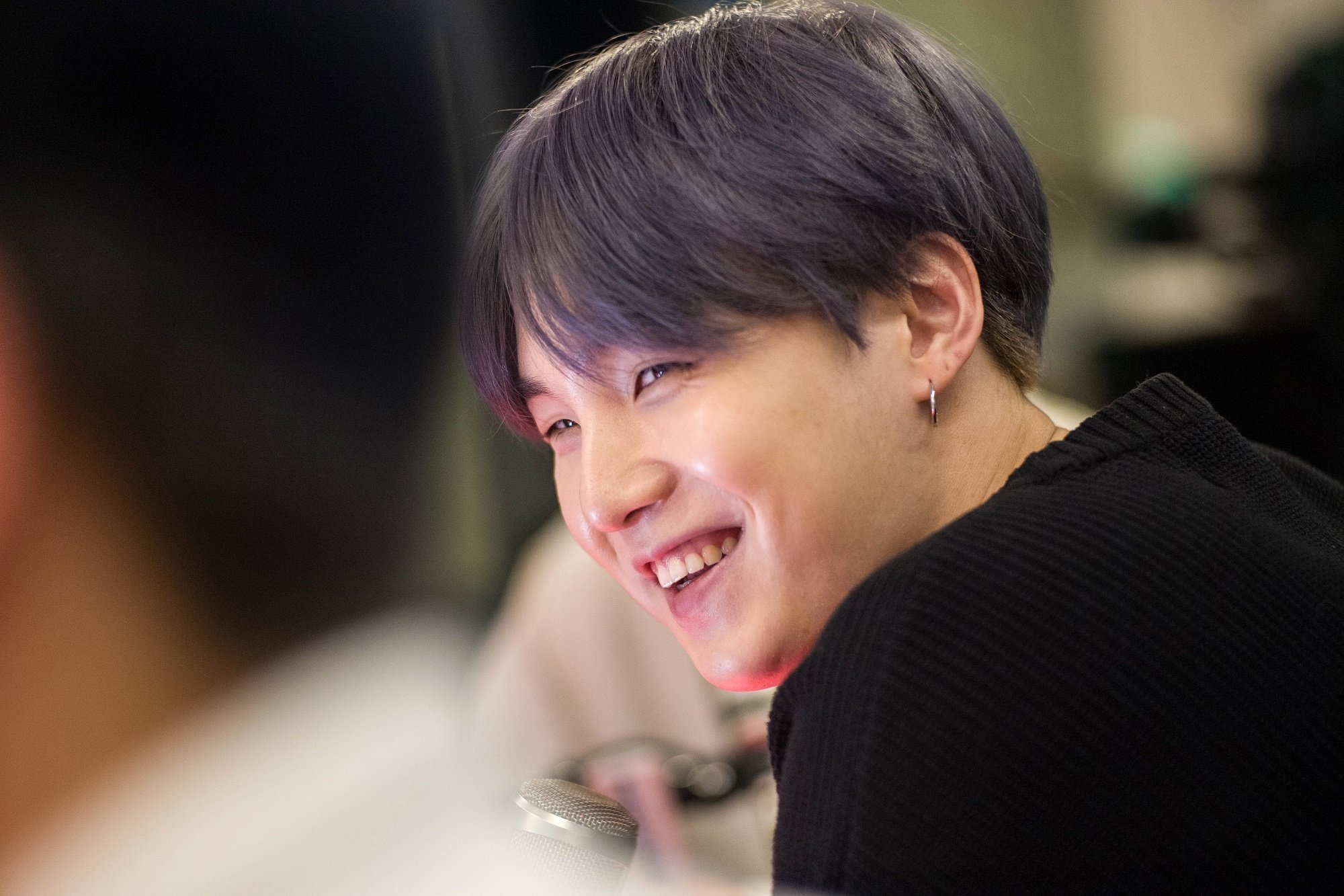 Suga of BTS smiles while visiting The Elvis Duran Z100 Morning Show in 2019