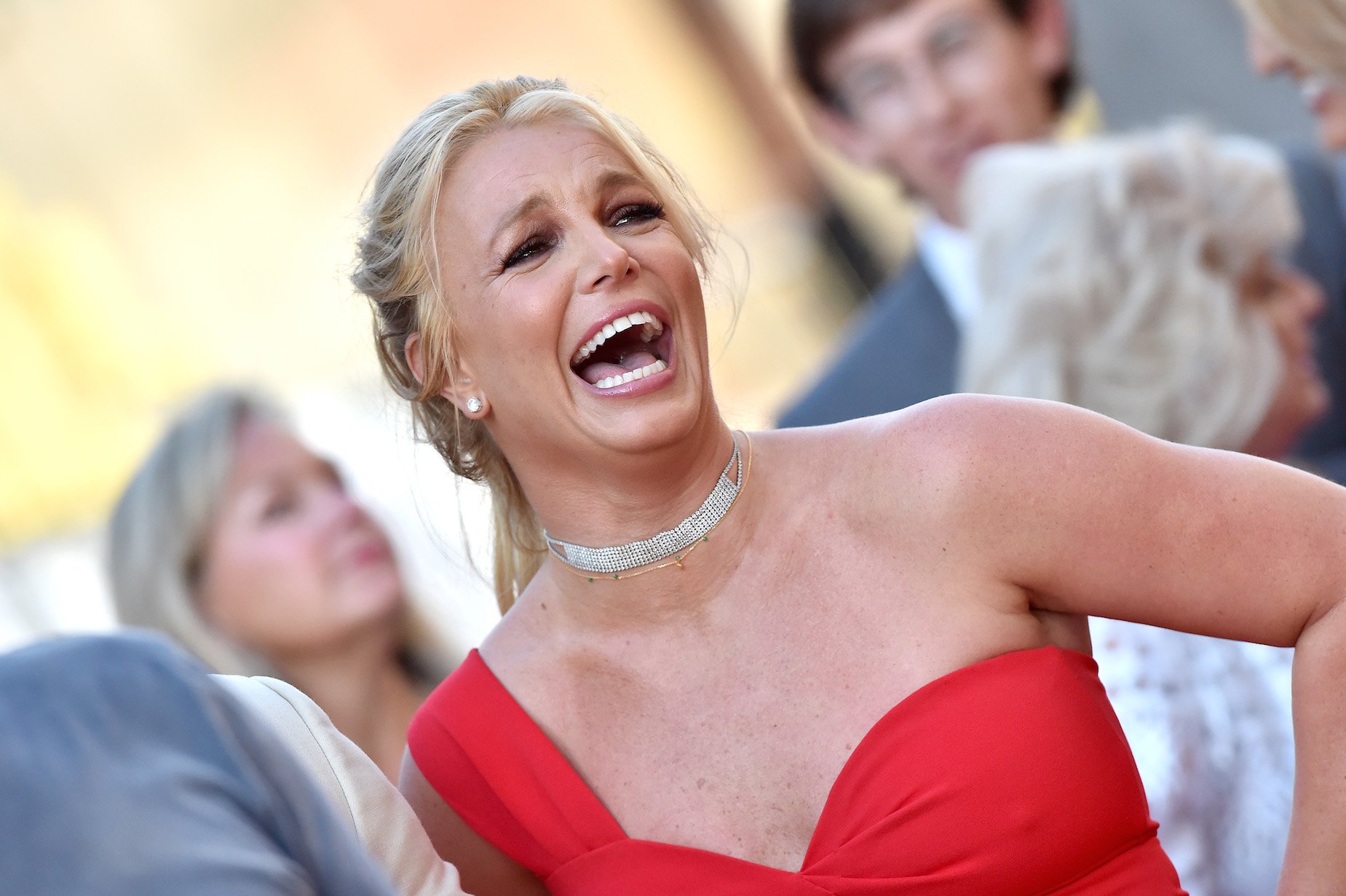 Britney Spears laughing while attending a movie premiere in 2019. Britney Spears' age is 37 in the photo.
