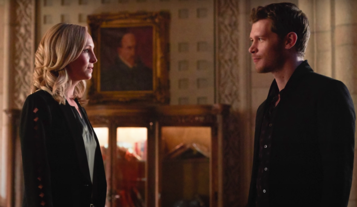 Candice King as Caroline Forbes and Joseph Morgan as Klaus Mikaelson standing face-to-face and grinning in 'The Originals' S5