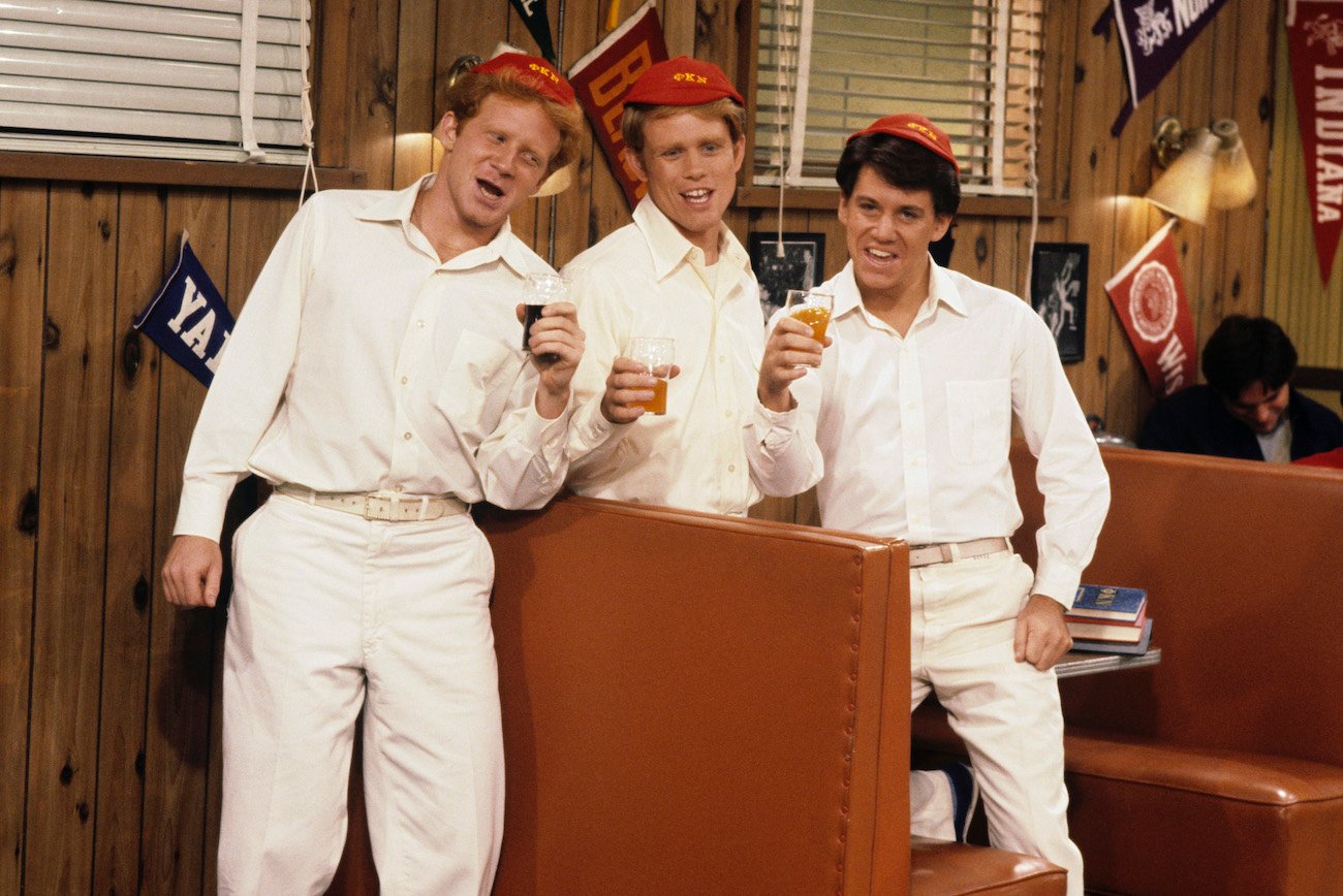 Donny Most, Ron Howard, and Anson Williams pose with beverages in a scene from 'Happy Days'