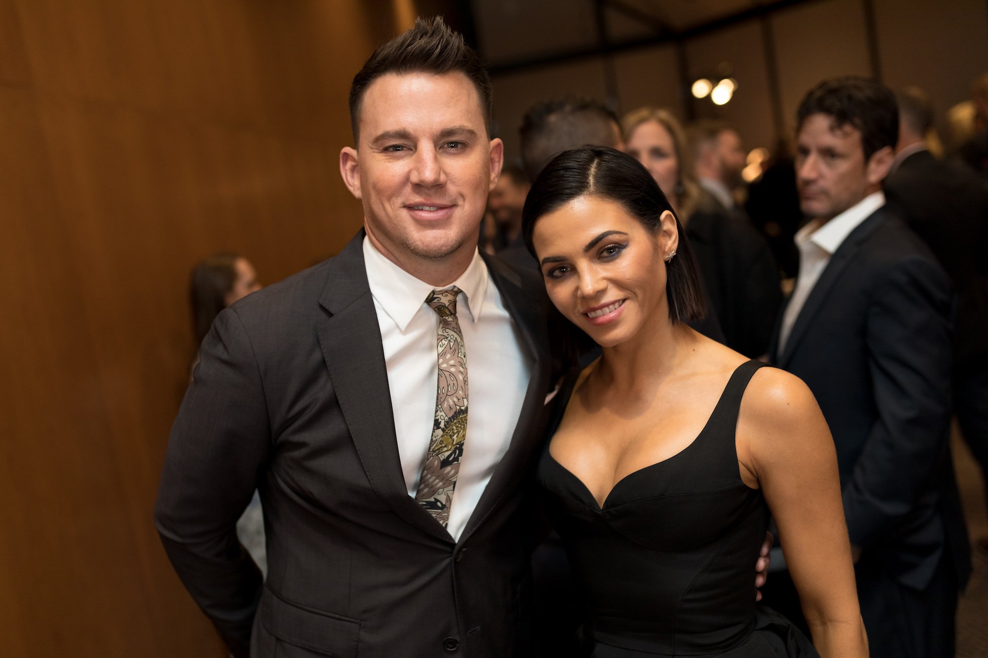 Channing Tatum and Jenna Dewan smiling in front of a crowd
