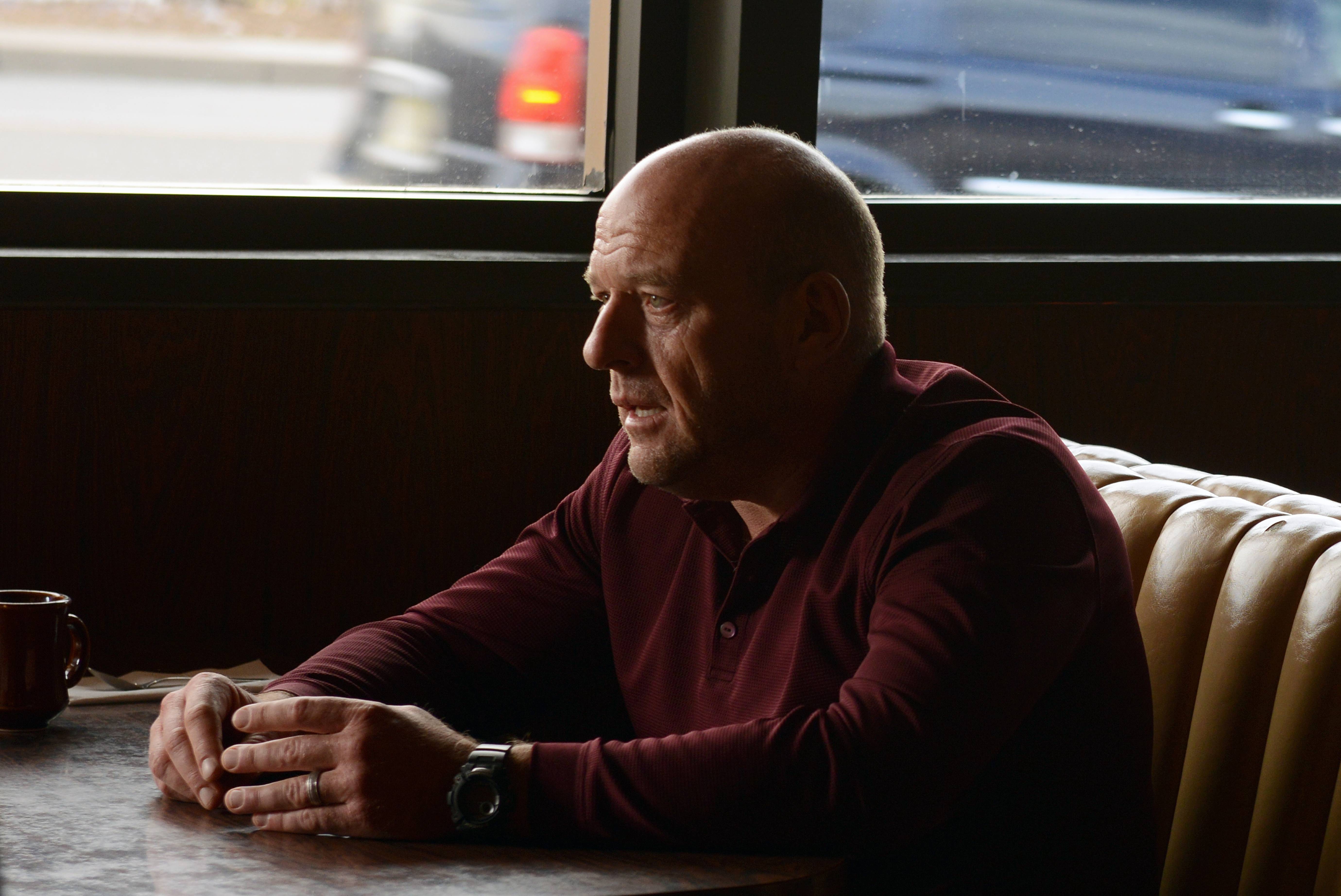 Dean Norris sits in a booth