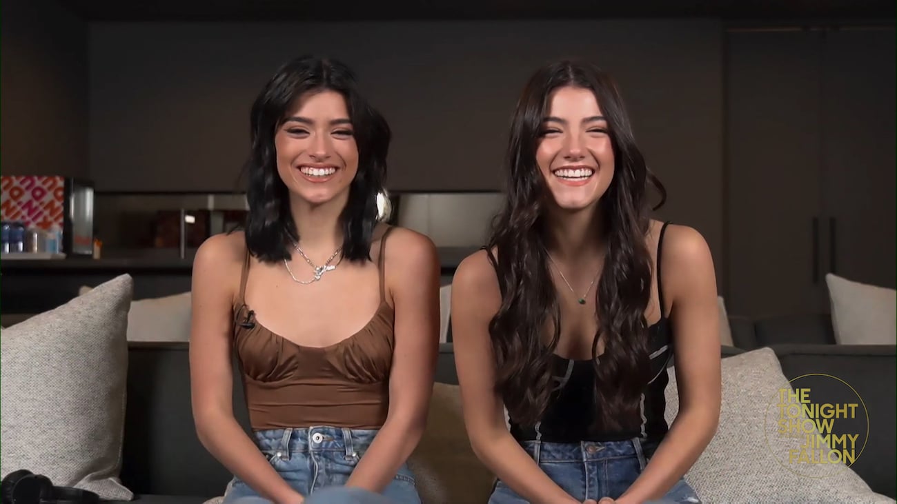 Dixie and Charli D'Amelio sitting on a couch together