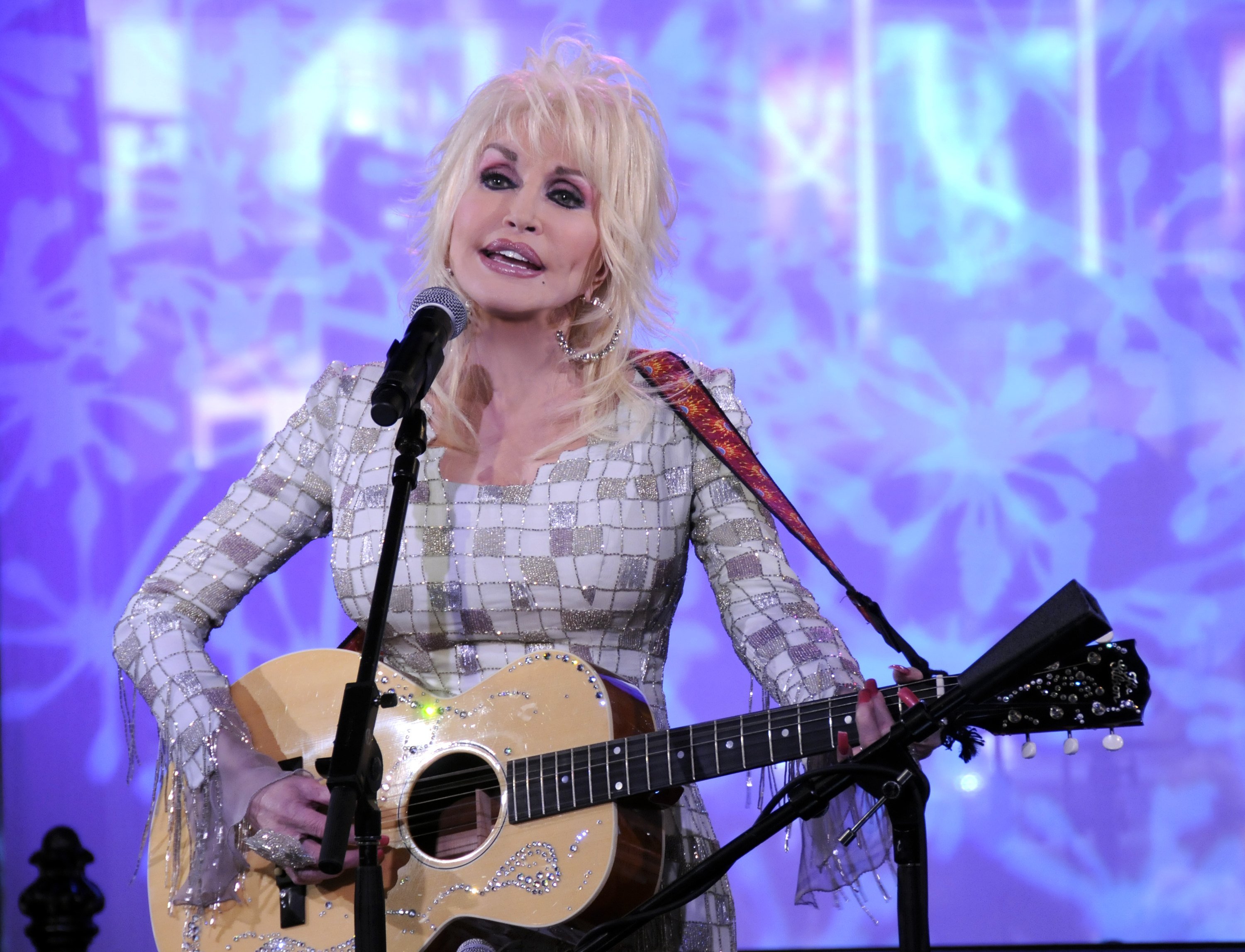 Dolly Parton playing guitar on 'Good Morning America.'