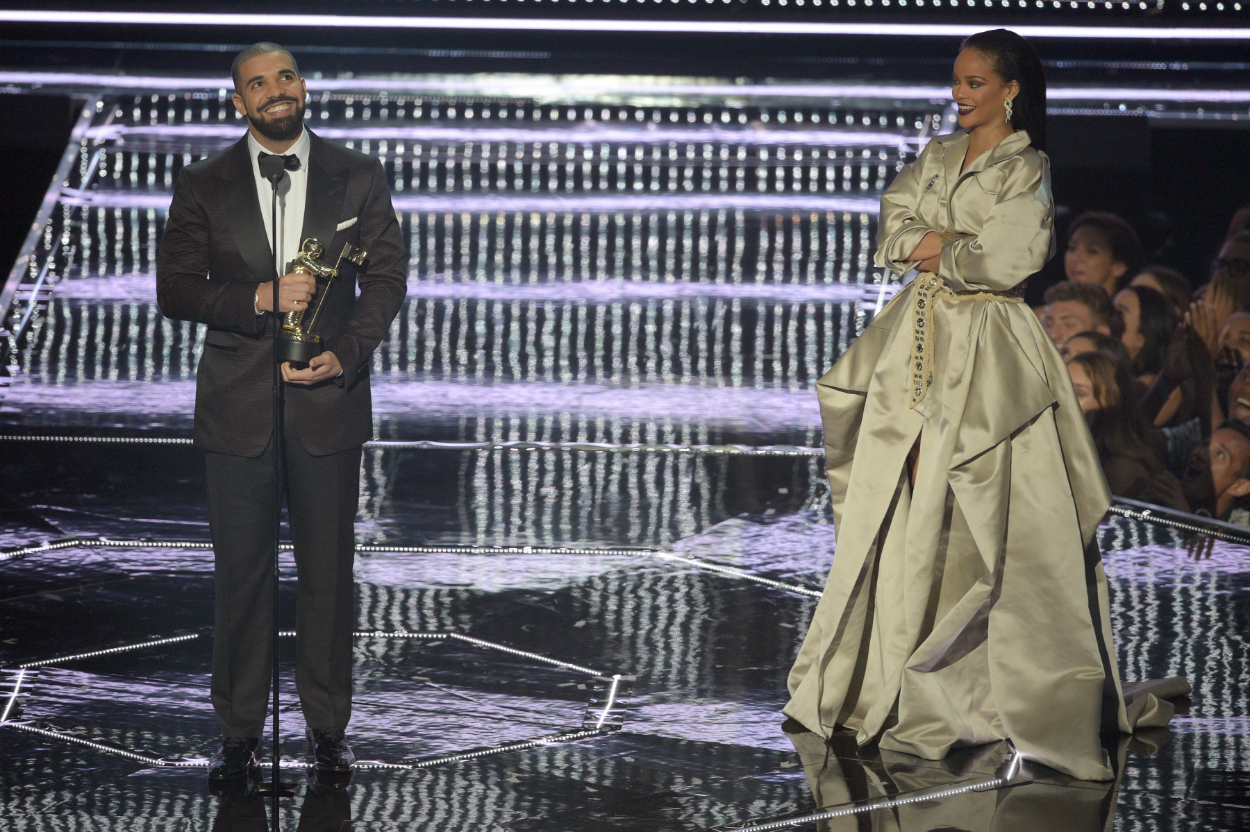 Drake presents the Video Vanguard award to Rihanna onstage during the 2016 MTV Music Video Awards