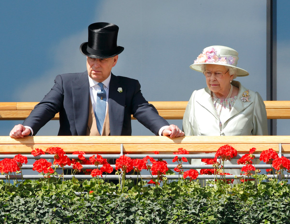Queen Elizabeth and Prince Andrew stand on the balcony of the Royal Ascot