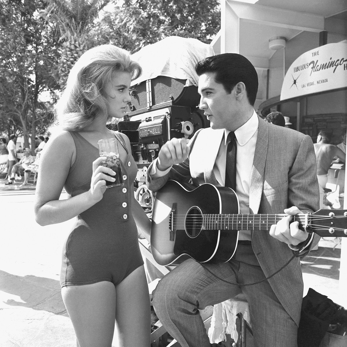 Ann-Margret in a bathing suit and Elvis Presley in a suit playing the guitar as their characters in 'Viva Las Vegas'