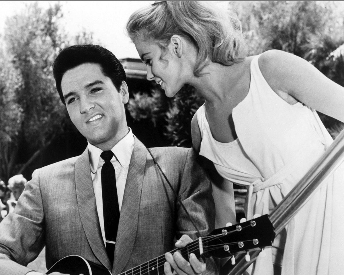 Elvis Presley singing to a smiling Ann-Margret in a scene from 'Viva Las Vegas' (1964). The photo is a black and white still from the film. 