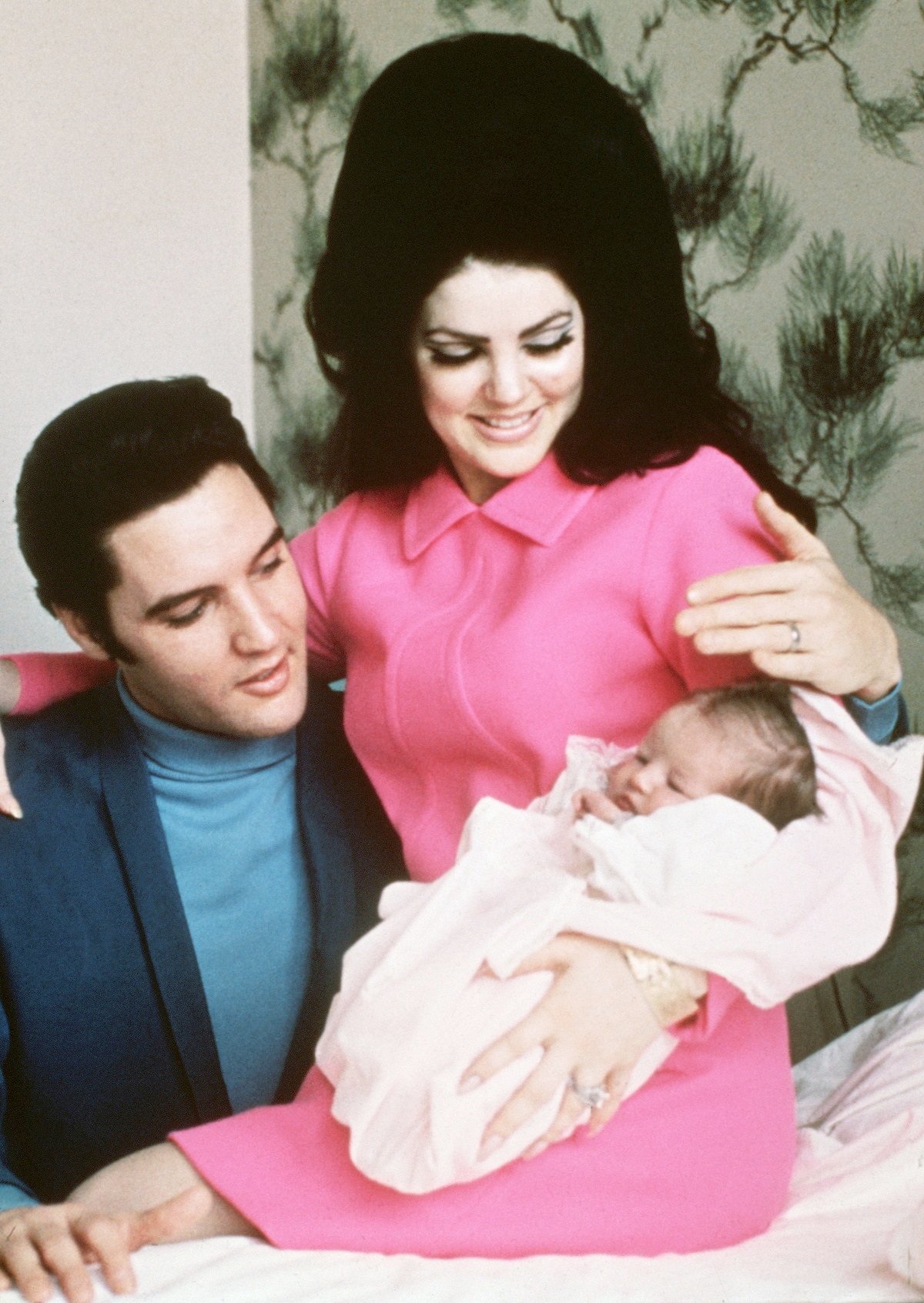 Elvis Presley and his wife, Priscilla, prepare to leave the hospital with their new daughter, Lisa Marie. They are smiling down at their new baby. Hospital in Memphis, Tennessee, February 5, 1968