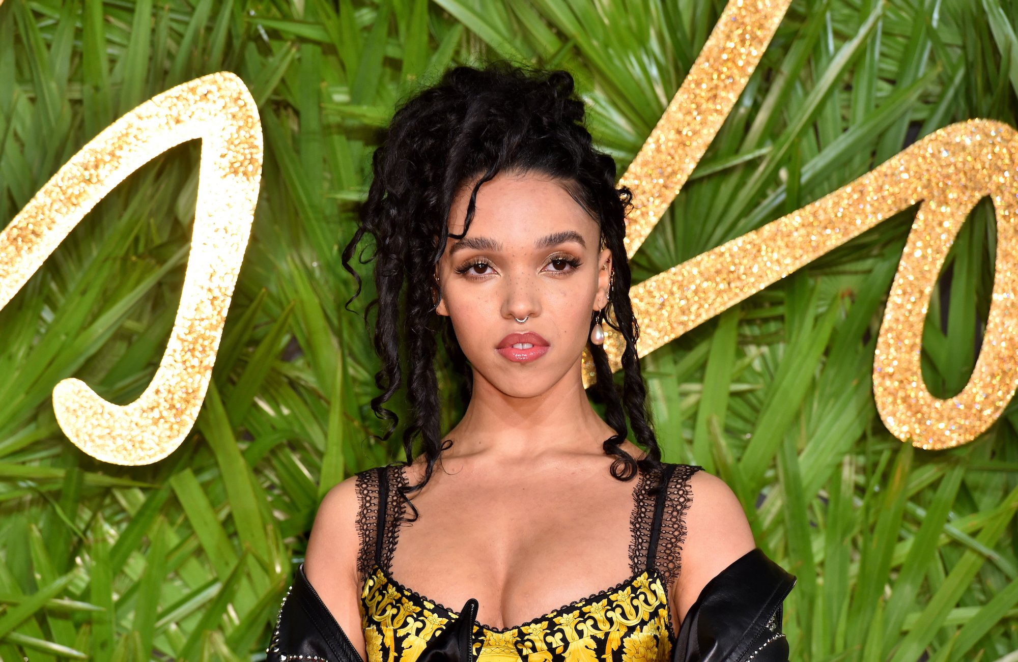 FKA Twigs in front of a green background