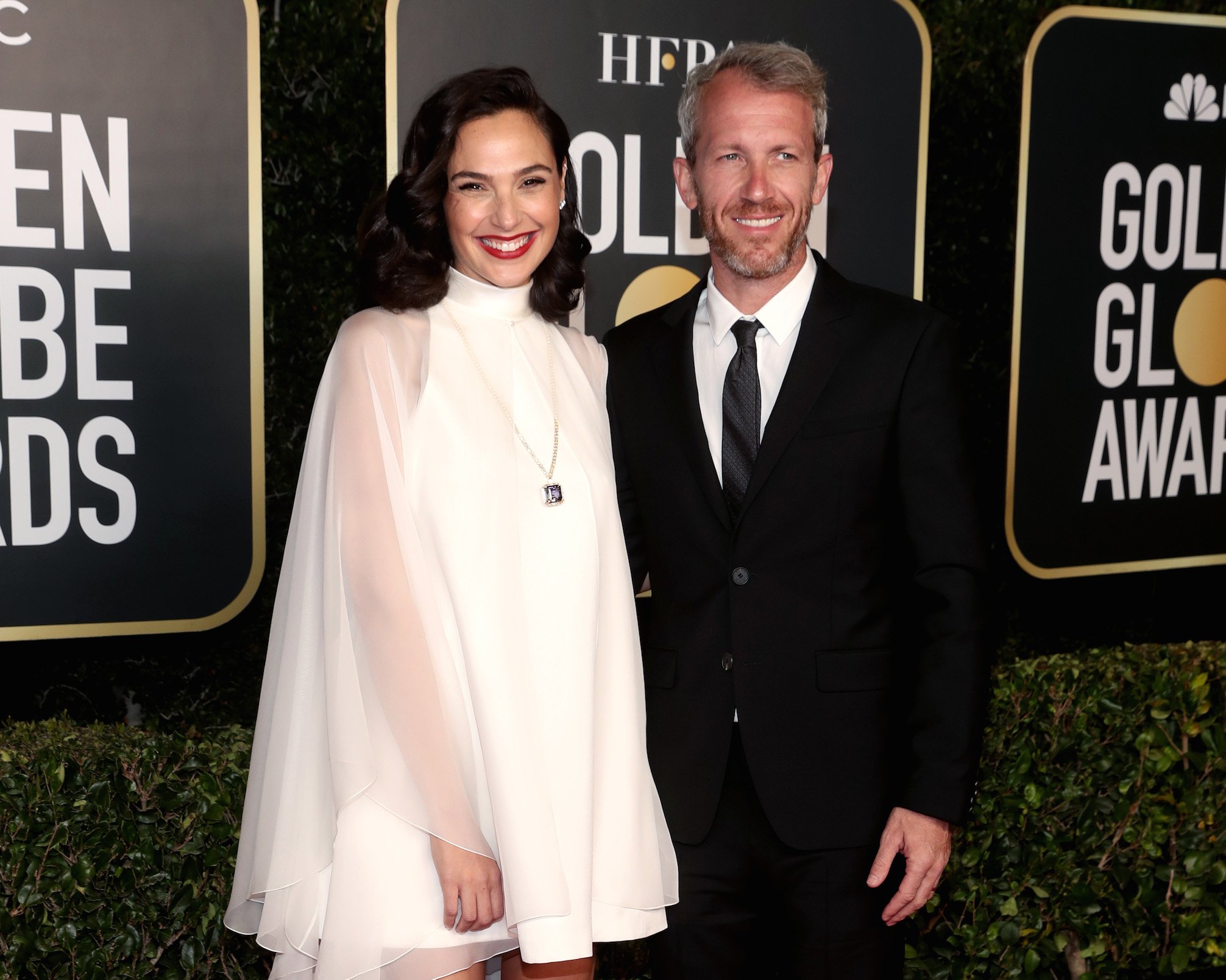 Gal Gadot and Gal Gadot's husband, Yaron Varsano, standing together at the 2021 Golden Globes