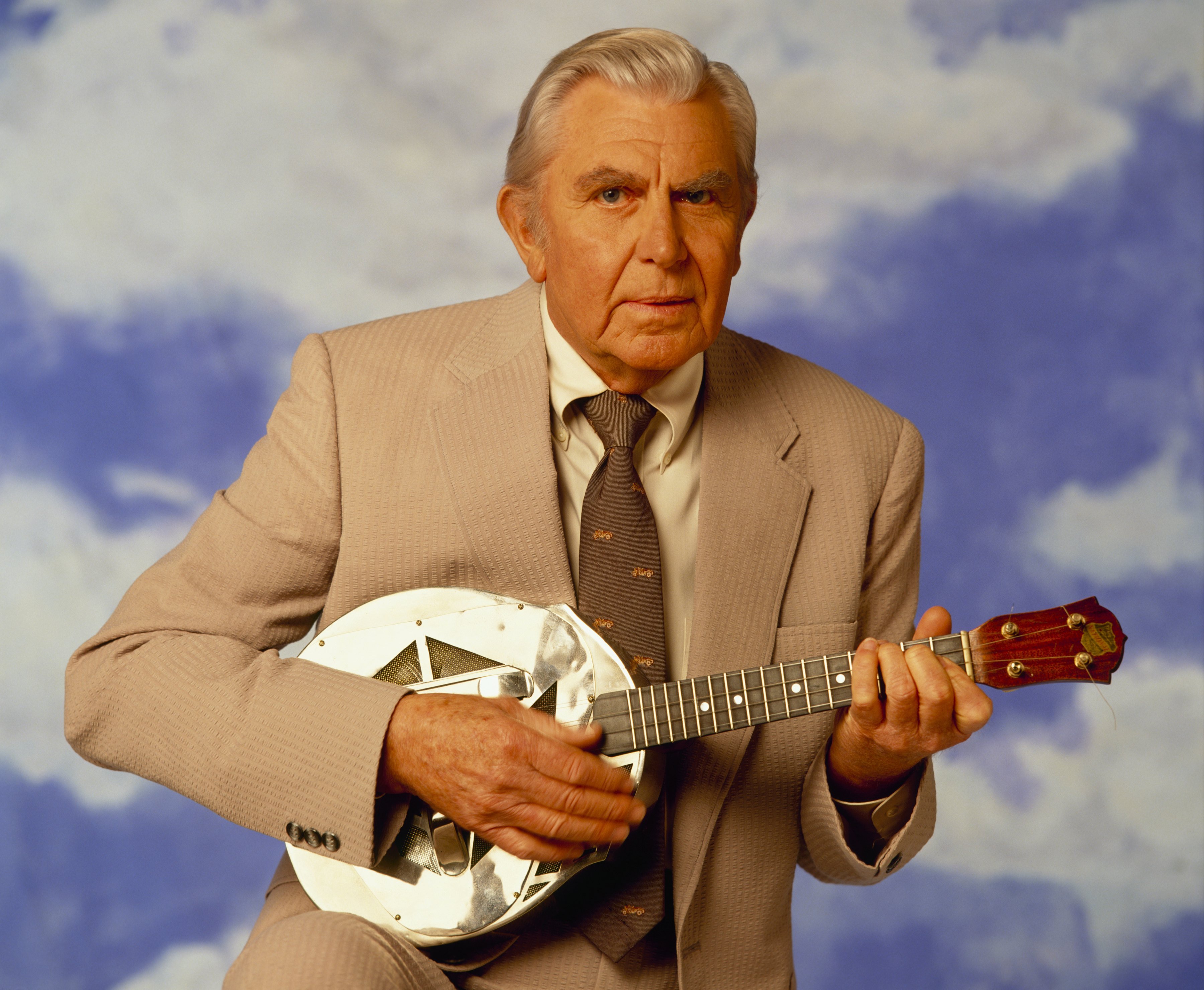 Andy Griffith as 'Matlock' holds a small guitar in 1992