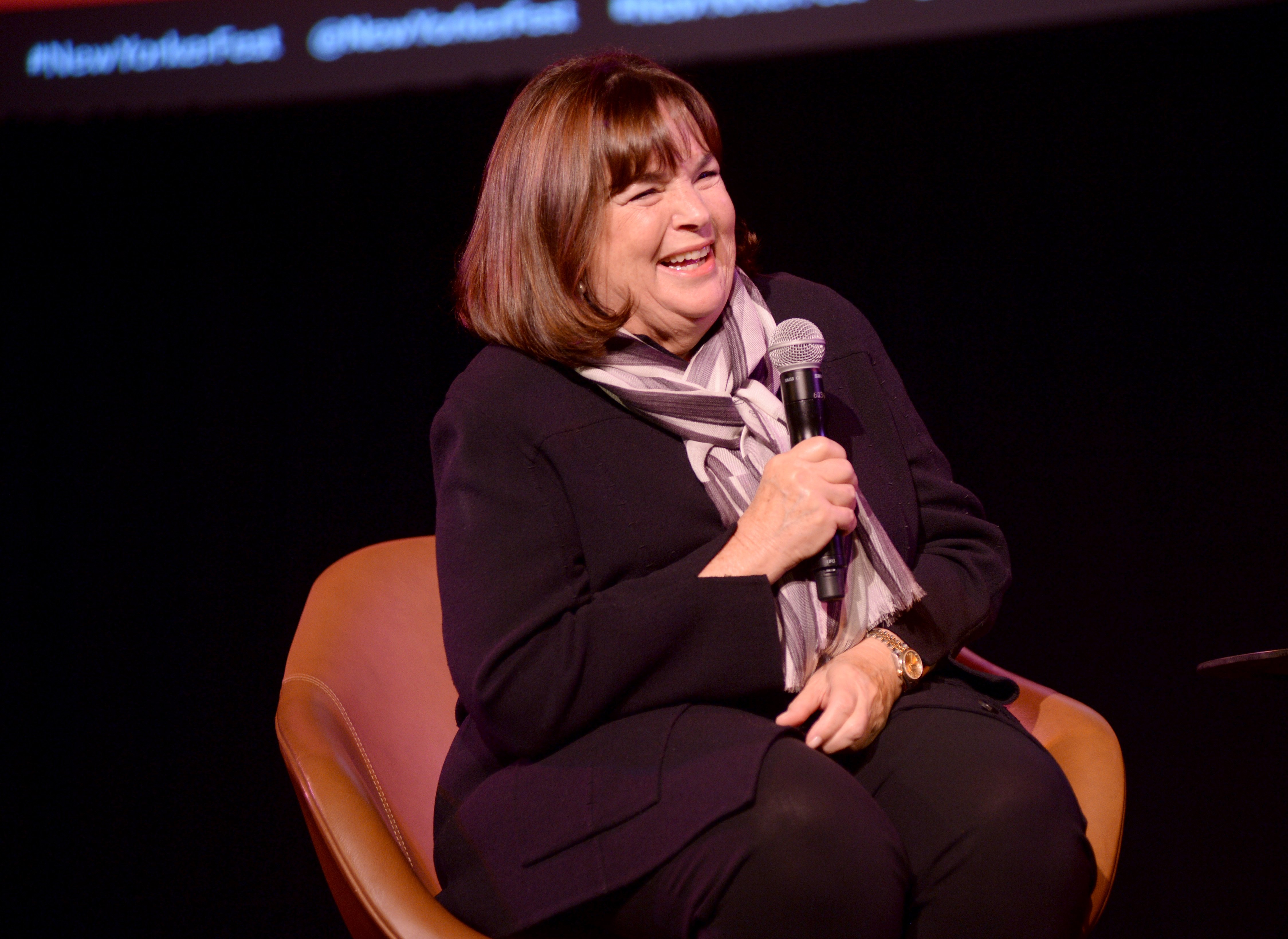 'Barefoot Contessa' star Ina Garten addresses an audience while sitting in an orange seat with a microphone in hand