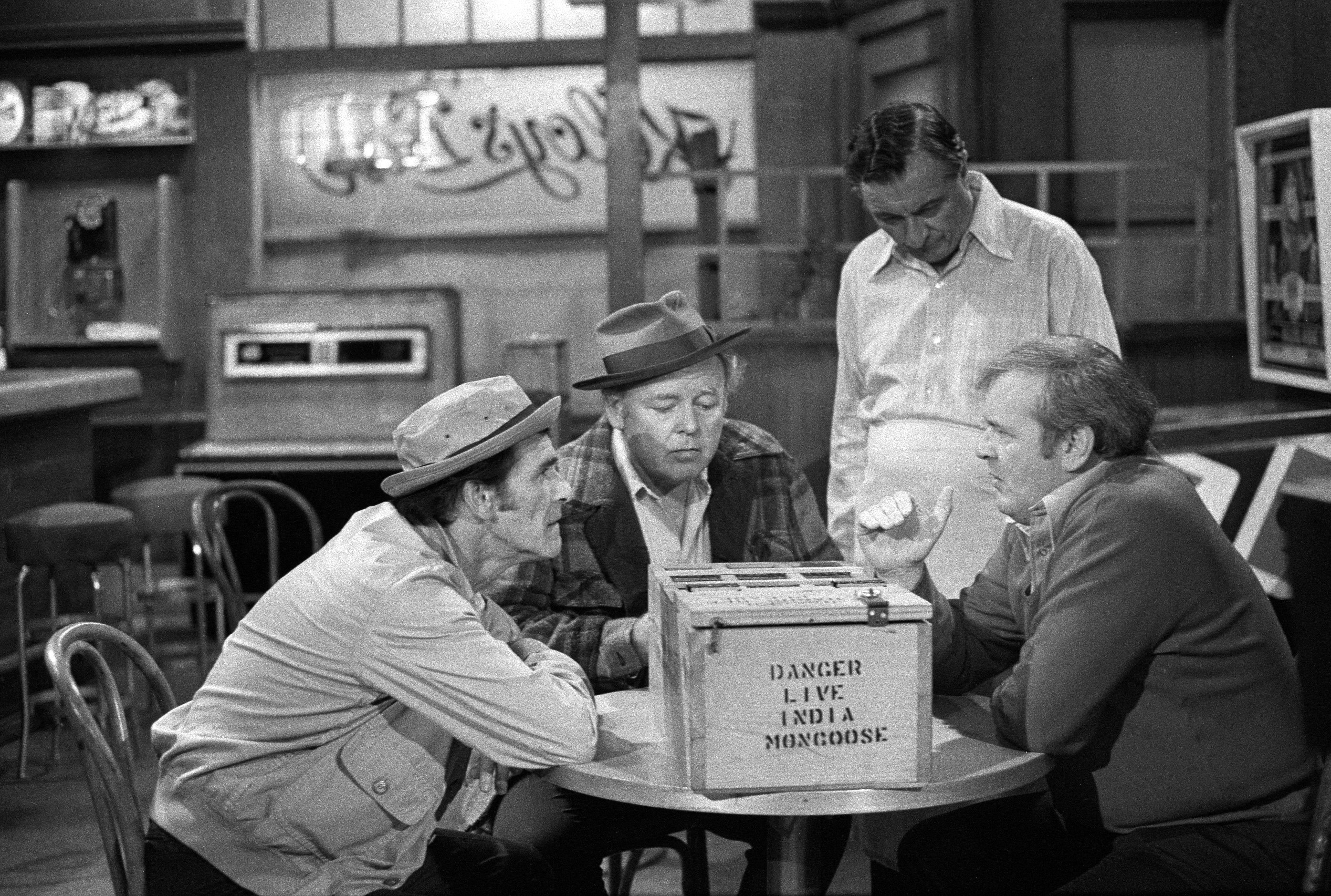 Carroll O'Connor, seated second from left in a scene from 'All in the Family', wearing the plaid coat that an 'Antiques Roadshow' appraiser placed at an auction value of $15,000