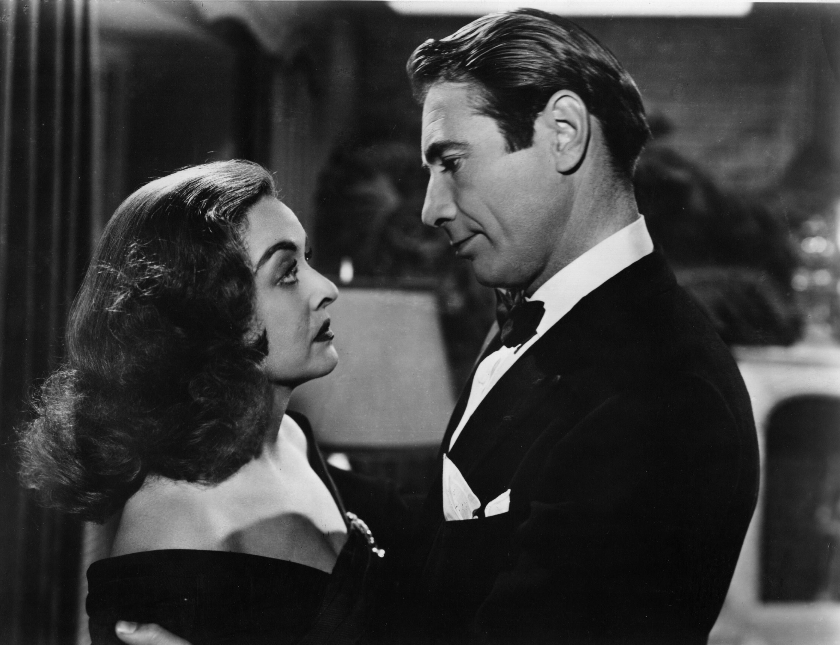 Bette Davis and former husband Gary Merrill embrace in a scene from 'All About Eve', 1950