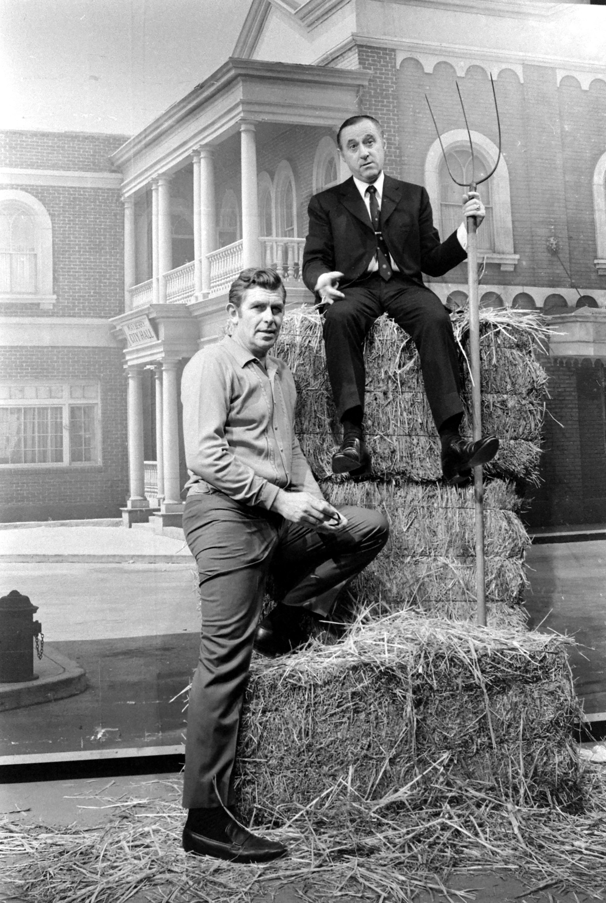 Andy Griffith (left) with his manager Dick Linke in 1969. The two pose on a stack of hay bales.