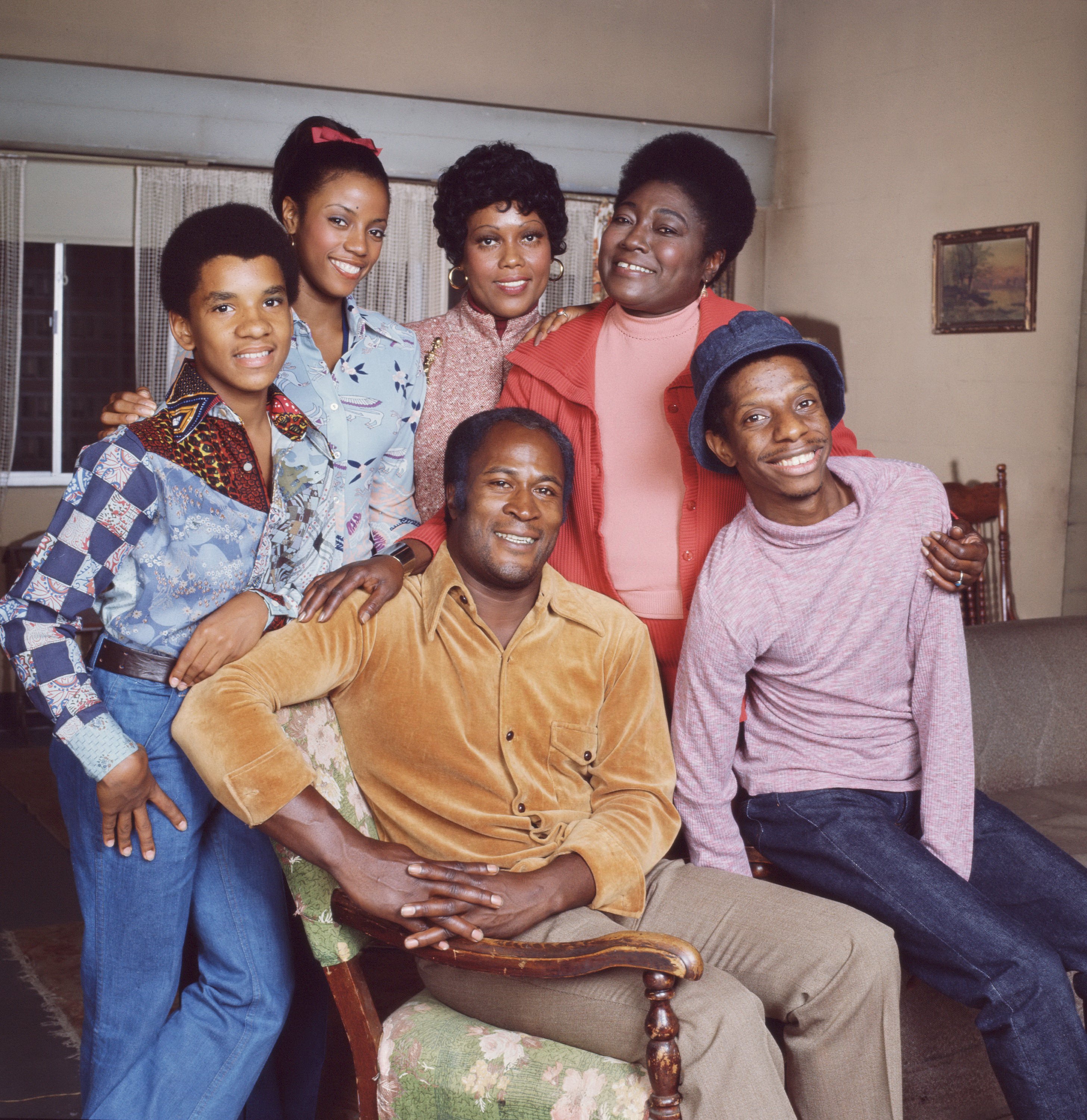 A portrait of the cast of 'Good Times': Pictured are, front row, American actors John Amos as James Evans (left) and Jimmie Walker as J.J. Evans; back row, from left, Ralph Carter as Michael Evans, Bern Nadette Stanis as Thelma Evans, Ja'net DuBois as neighbor Willona Woods, and  Esther Rolle as Florida Evans