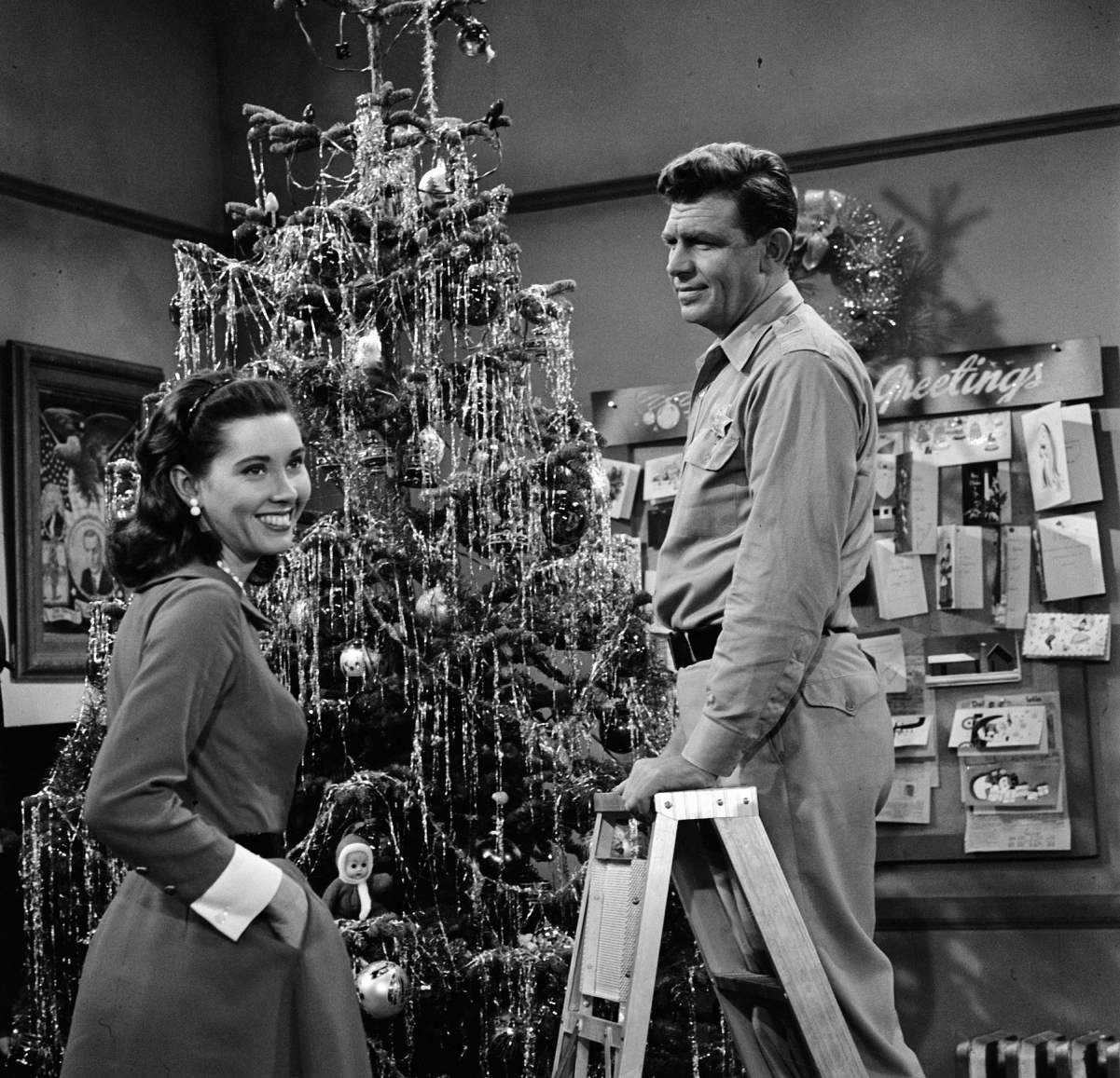 (L to R): Actor Elinor Donahue as Ellie Walker and Andy Griffith as Sheriff Andy Taylor decorate a Christmas tree in a scene from 'The Andy Griffith Show'