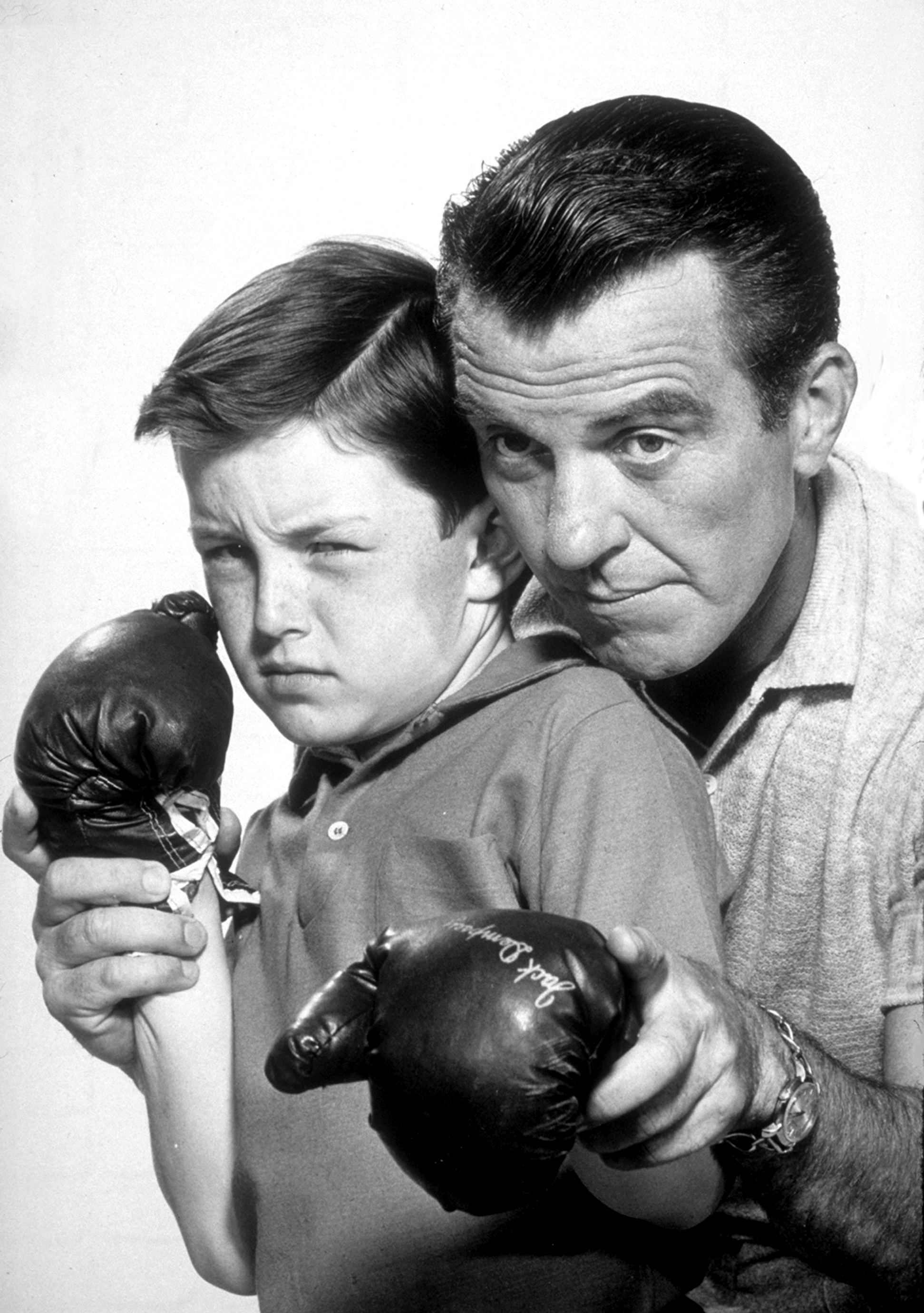 Hugh Beaumont, right, gives Jerry Mathers a boxing lesson in a scene from 'Leave It to Beaver,' 1959