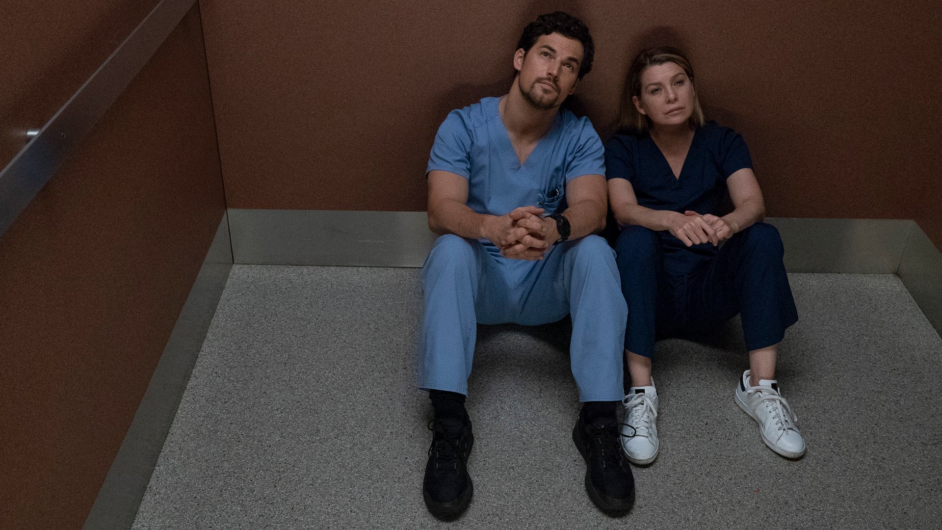 Giacomo Gianniotti as Andrew DeLuca and Ellen Pompeo as Meredith Grey sitting in the elevator in 'Grey's Anatomy' Season 15