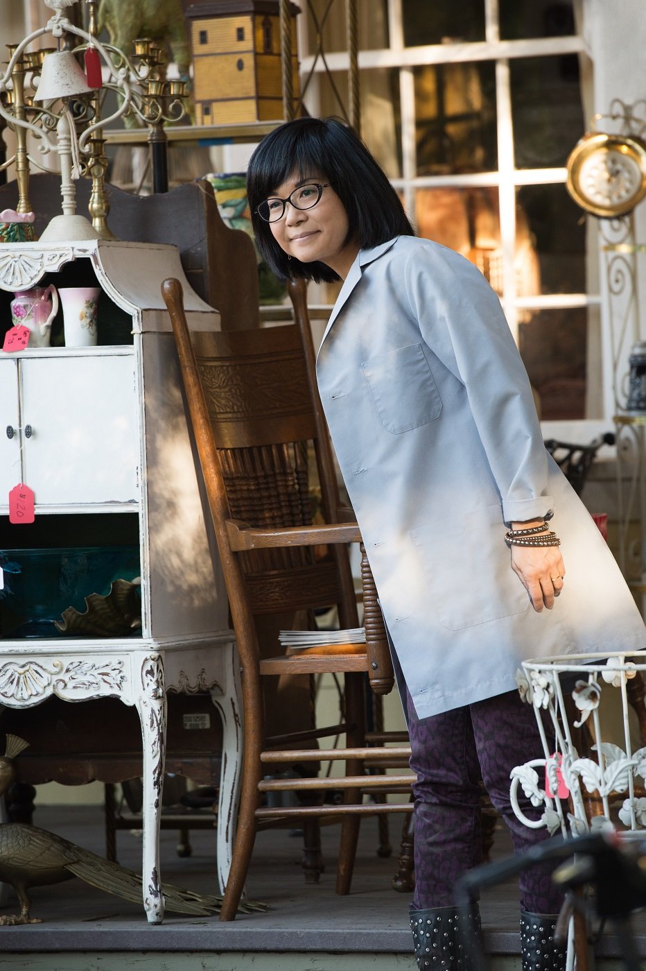 Keiko Agena as Lane Kim stands in front of Kim's Antiques in a scene for 'Gilmore Girls: A Year in the Life'