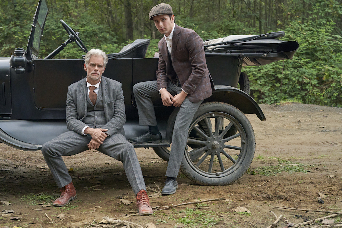 Gowen and Chrisopher sitting on a car's running board in When Calls the Heart