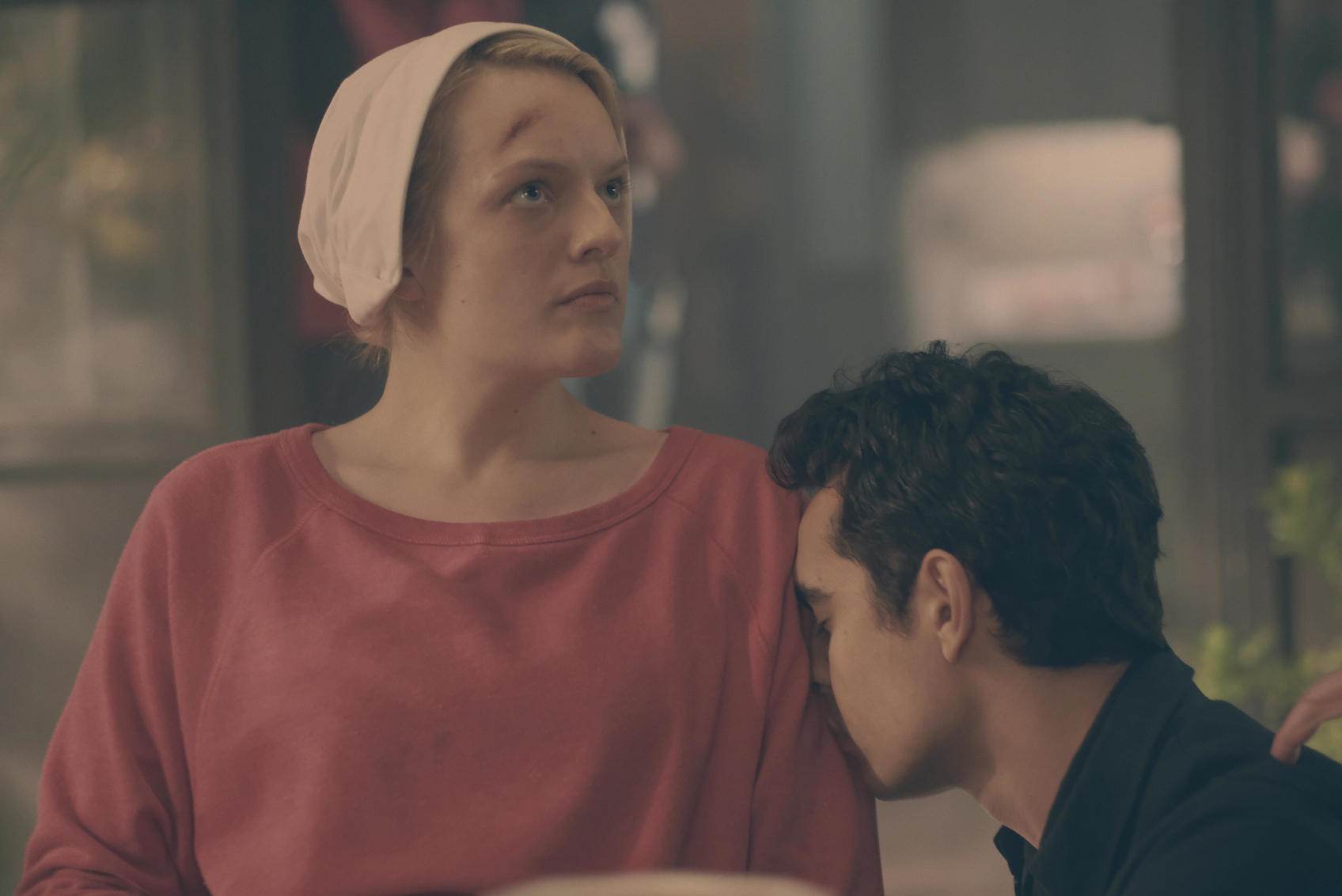 'The Handmaid's Tale' Season 4 star Elisabeth Moss as June Osborne allowing actor Max Minghella as Nick to rest his head on her shoulder