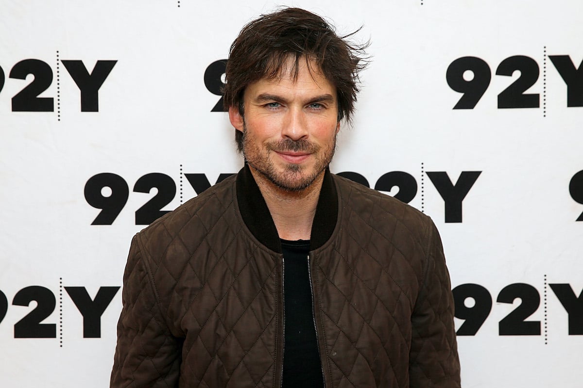 Ian Somerhalder in a brown bomber jacket and black shirt in front of a white background that says '92Y' in black lettering | Dominik Bindl/Getty Images