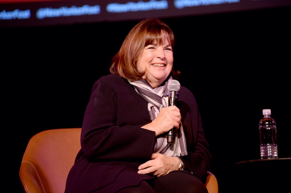 Ina Garten sits onstage as she smiles and speaks into a microphone at an event during the 2019 New Yorker Festival