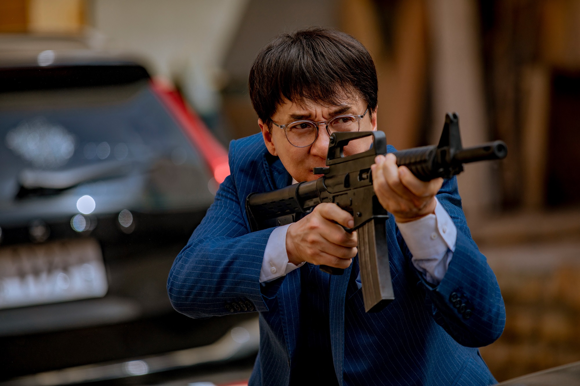 Jackie Chan with a machine gun