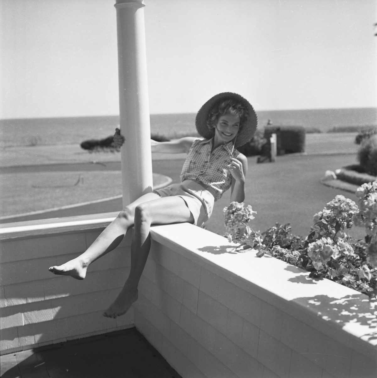 Jacqueline Bouvier on vacation smiling in 1953