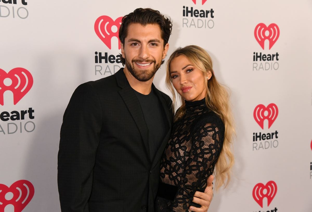 Jason Tartick and Kaitlyn Bristowe pose together at the 2020 iHeartRadio Podcast Awards